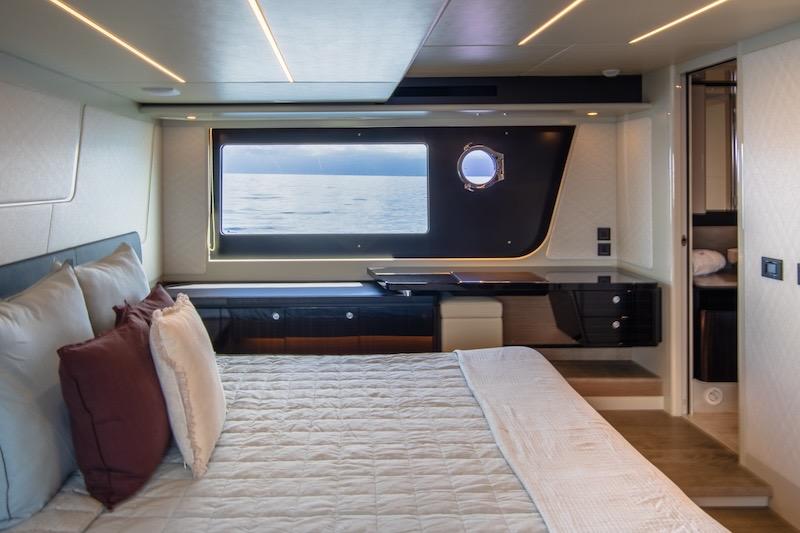 Luxurious bedroom interior of 2023 Absolute 62 Fly yacht with ocean view.