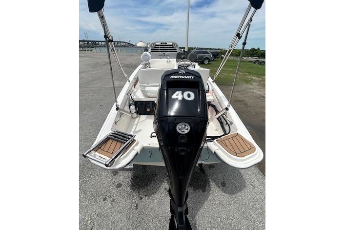 2020 Boston Whaler 130 Super Sport boat with Mercury 40 engine, docked on a sunny day.
