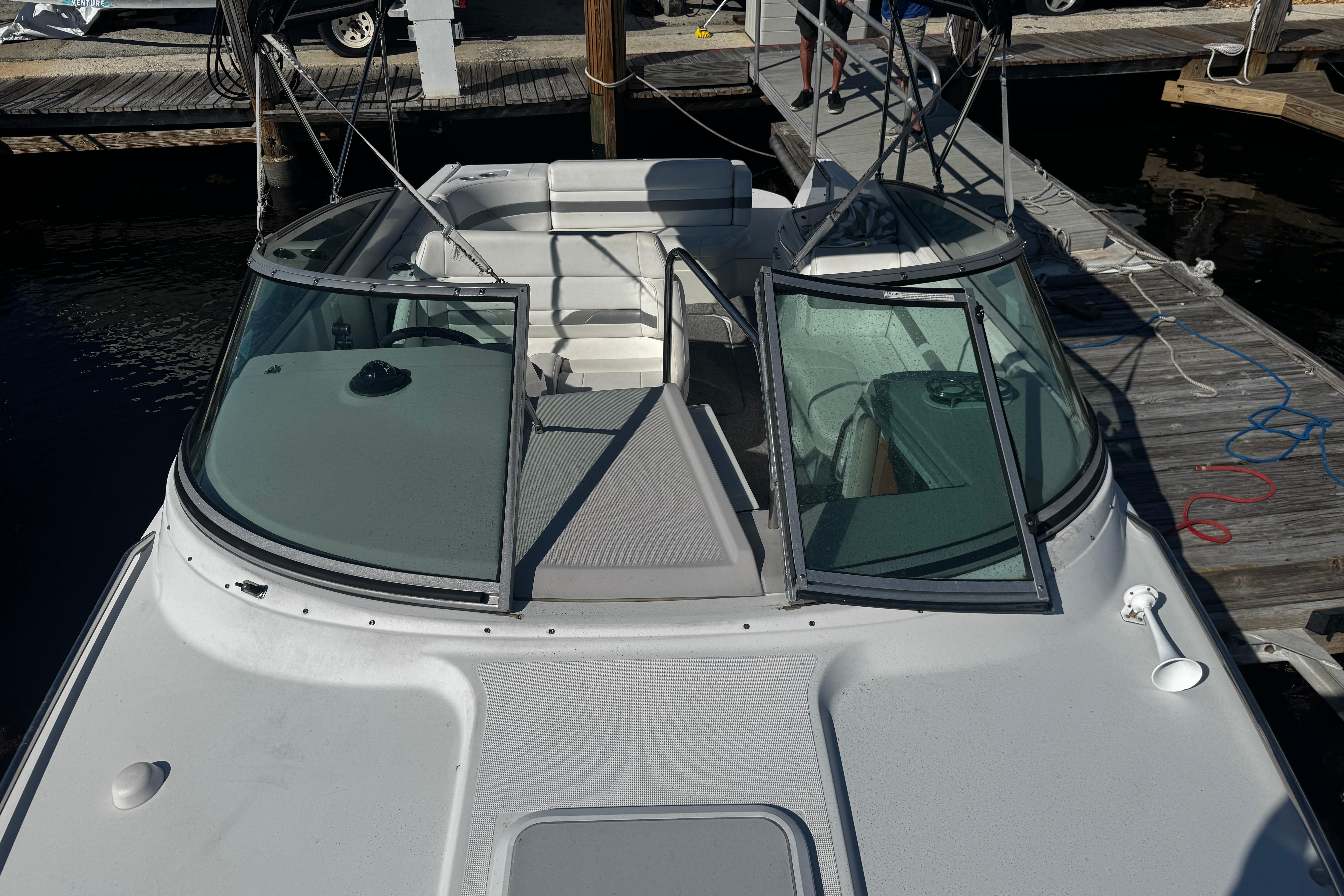 2004 Formula 280 Sun Sport boat docked, featuring open cockpit and windshield.