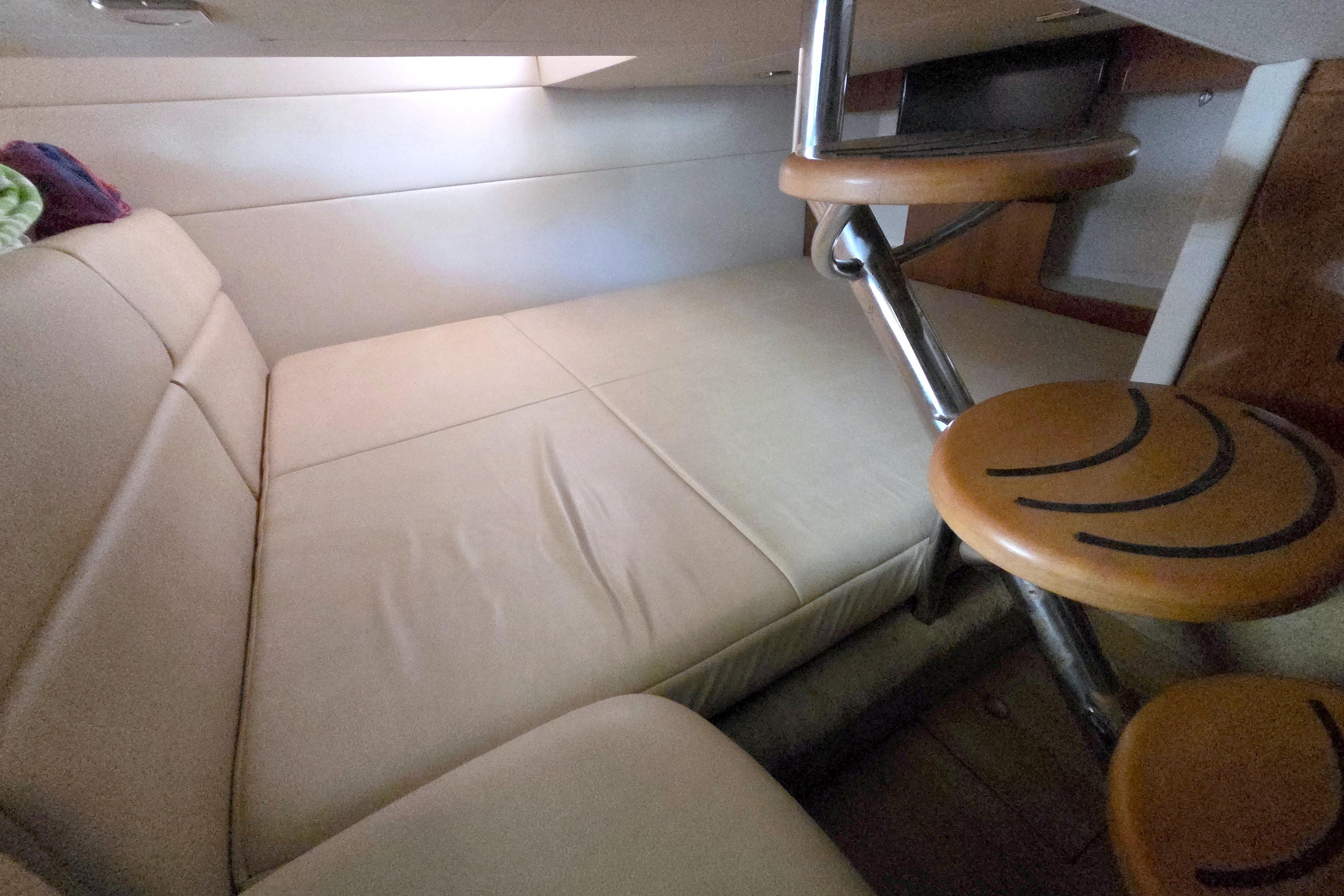2015 Formula 350 Crossover Bowrider cabin interior with beige seating and wooden steps.