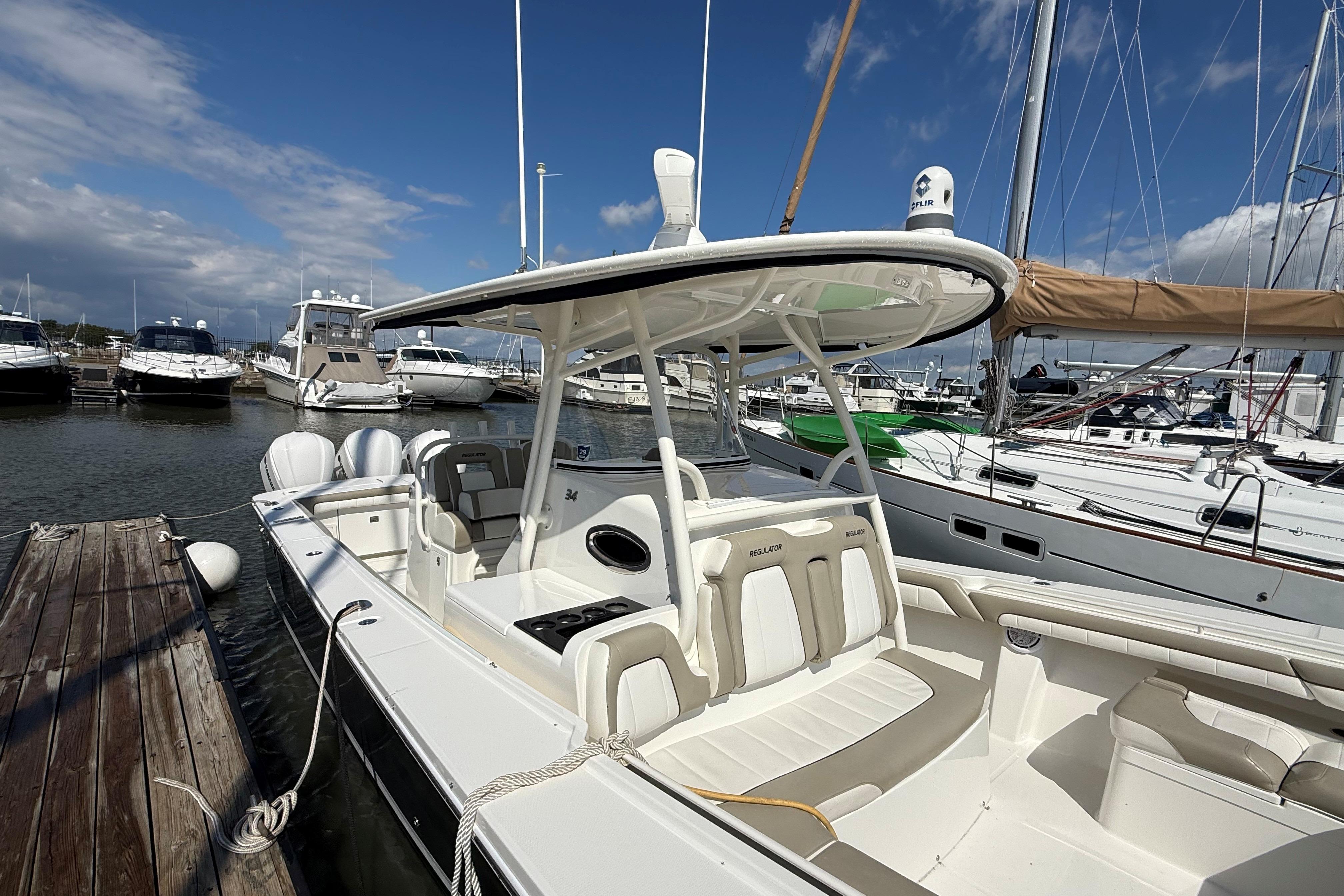 2019 Regulator 34SS boat docked at marina with clear blue sky.