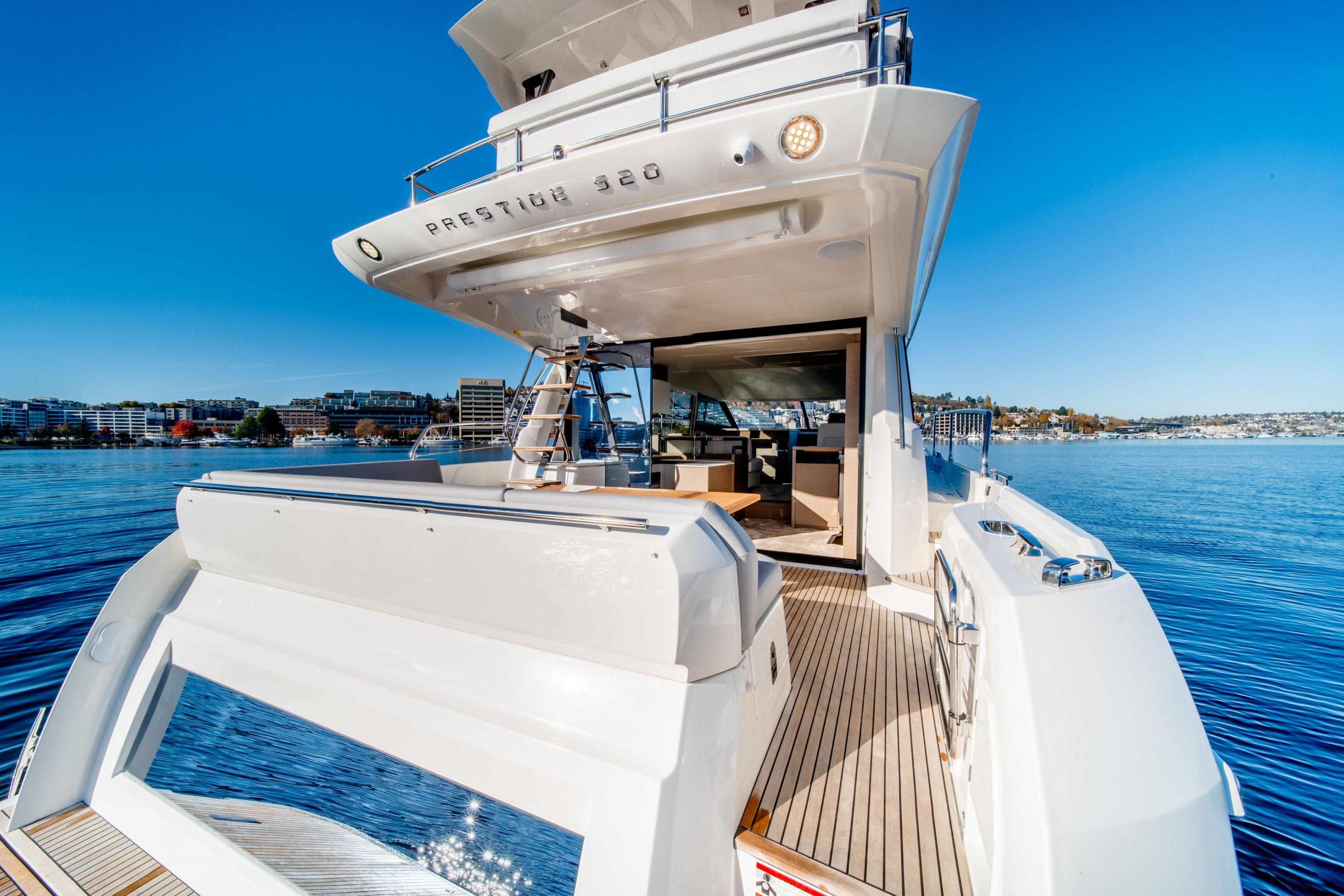 Luxury Prestige 520 yacht on serene water, showcasing sleek design, 2026 model.