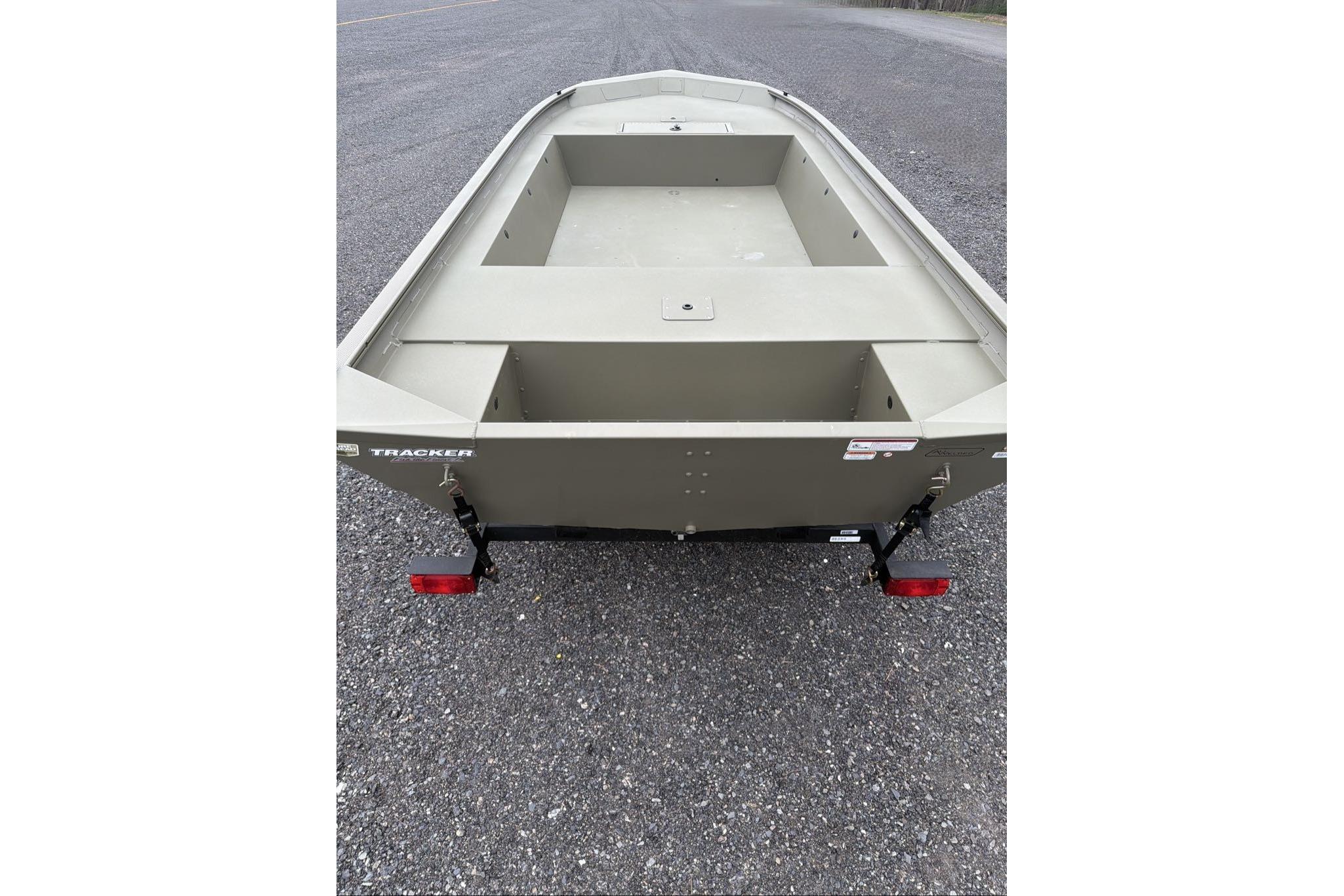 2026 Tracker Grizzly 1754 Utility boat on trailer, parked on asphalt.
