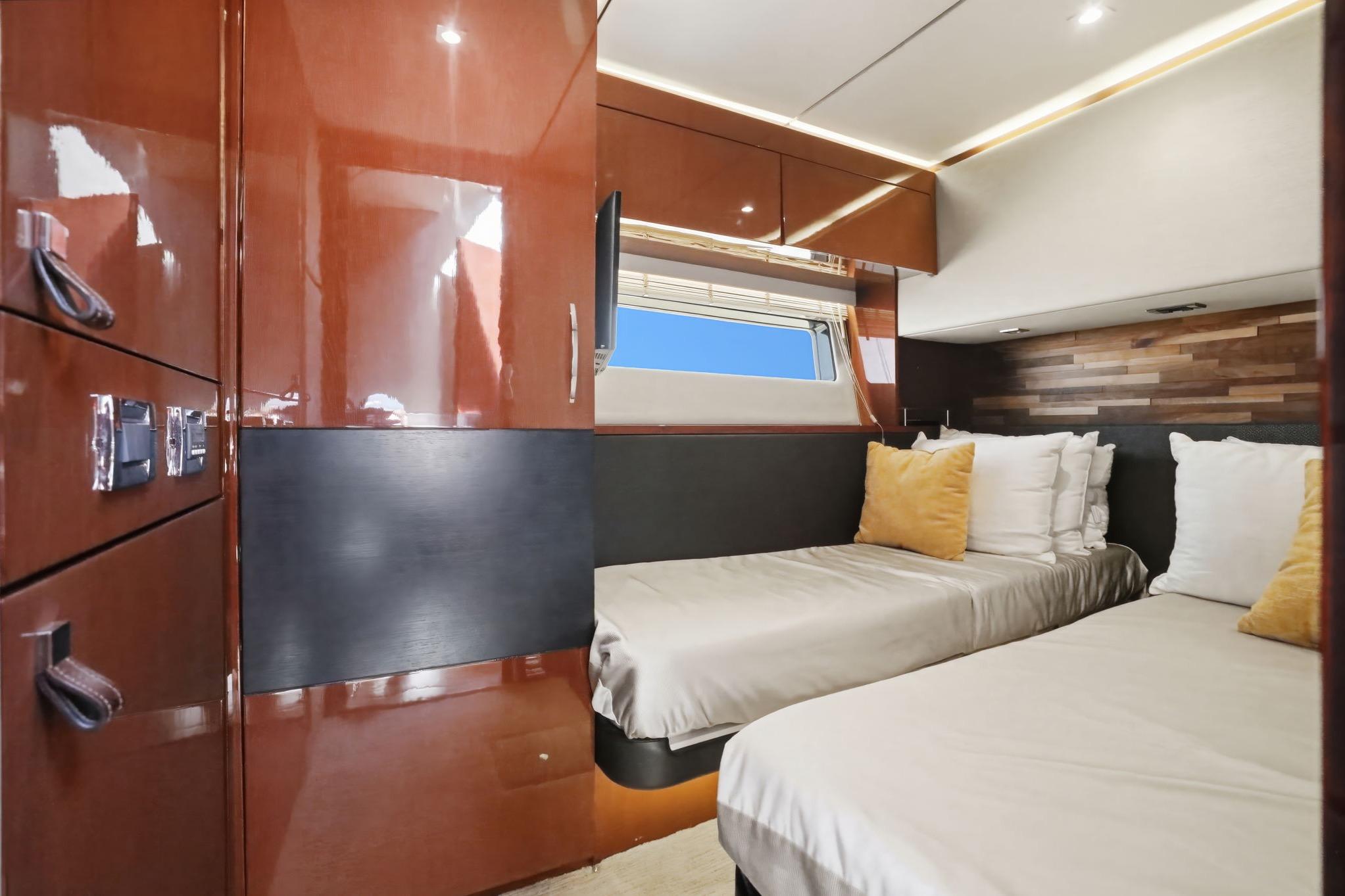 Luxurious 2017 Sea Ray L590 yacht cabin with twin beds and elegant wood finishes.