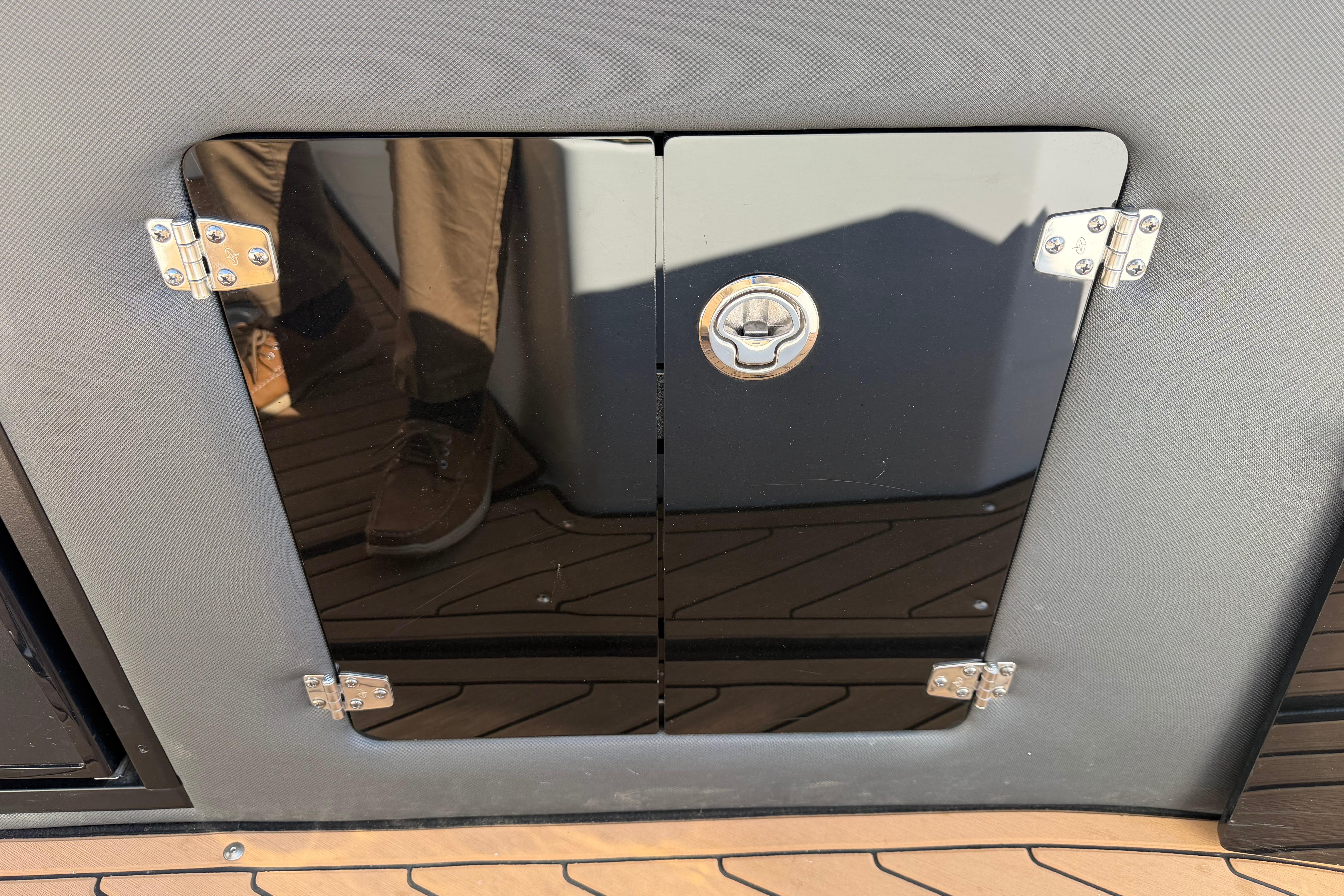 2019 Rinker EX 320 boat compartment door with chrome hinges and handle.