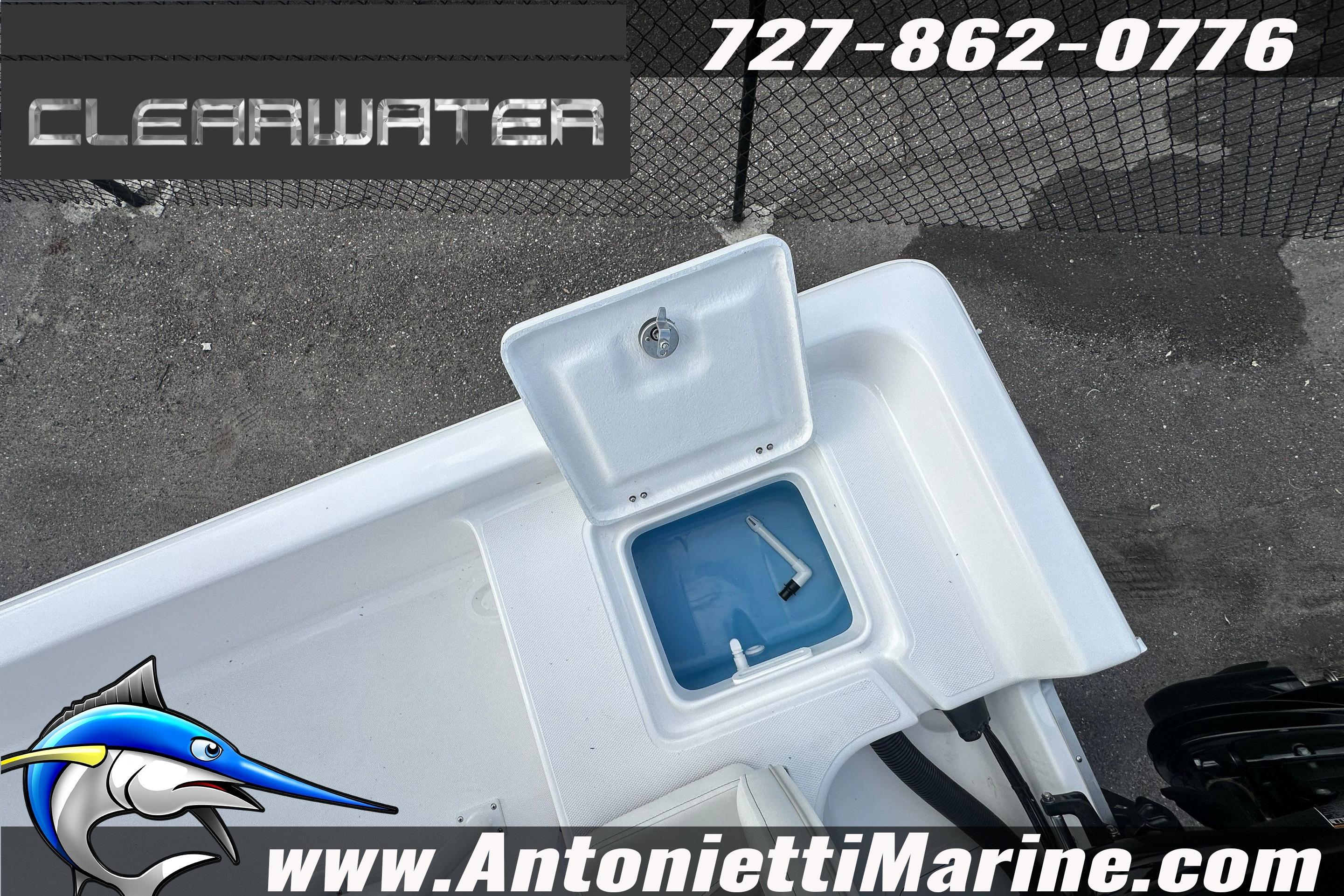 Clearwater 2100 Bay 2026 boat with open storage compartment.