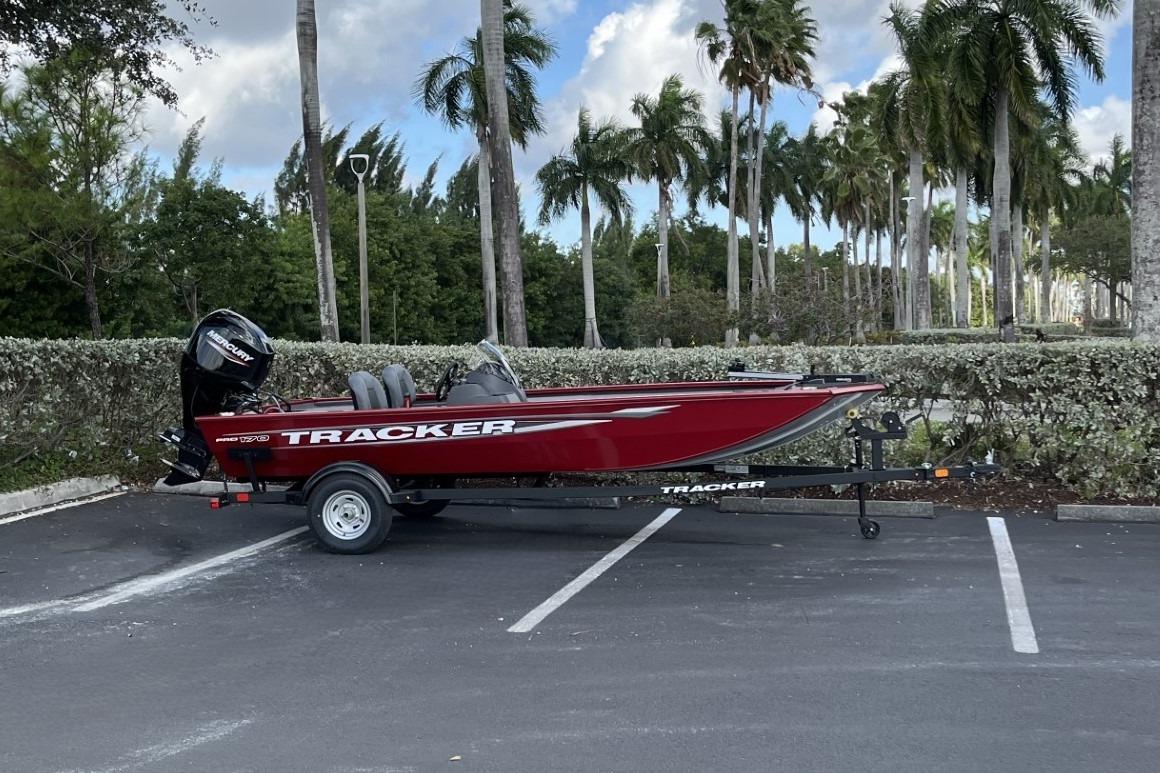 2026 Tracker Pro 170 boat in parking lot with palm trees in background.