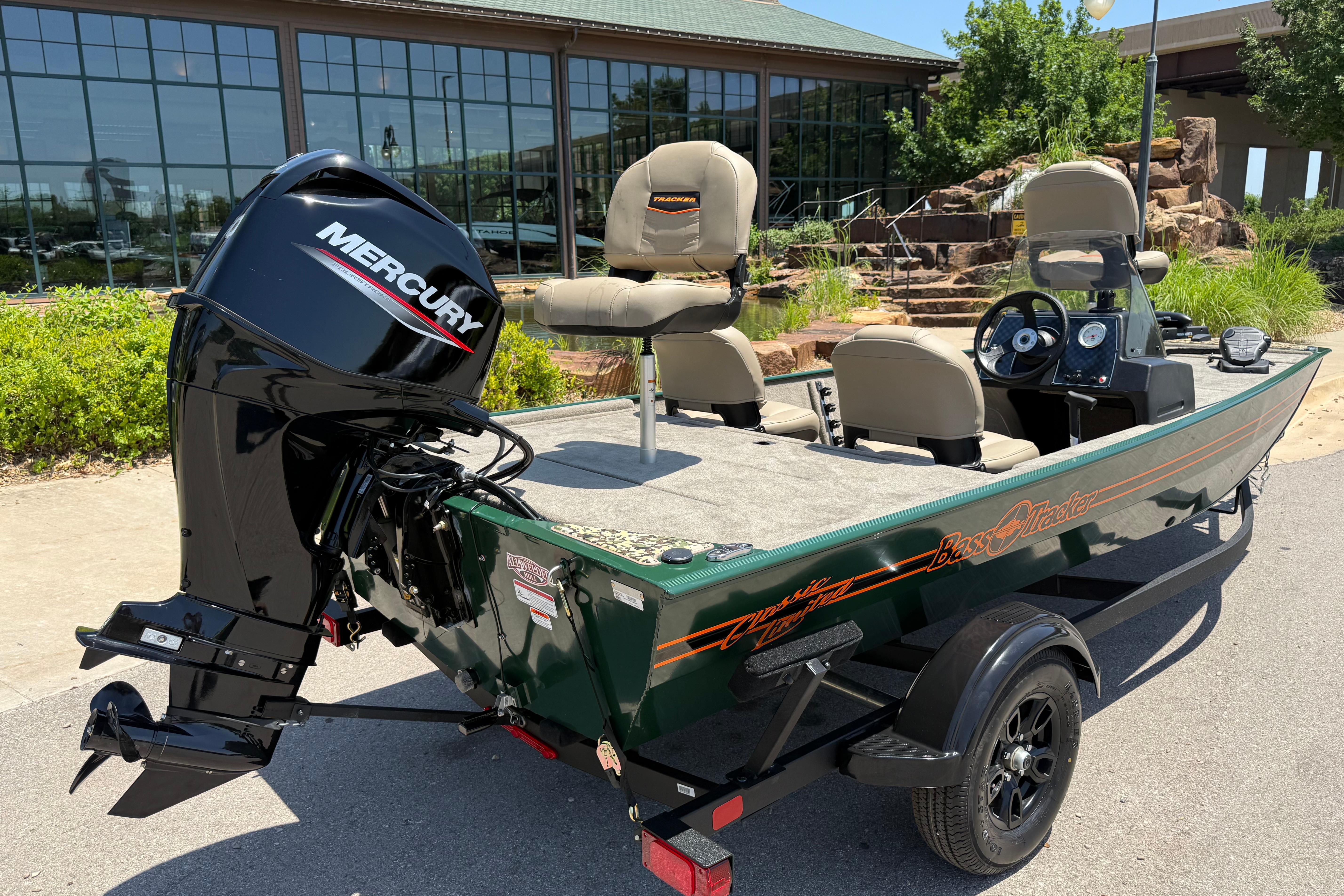 2026 Tracker Bass Tracker Classic Limited boat with Mercury engine, parked outdoors.