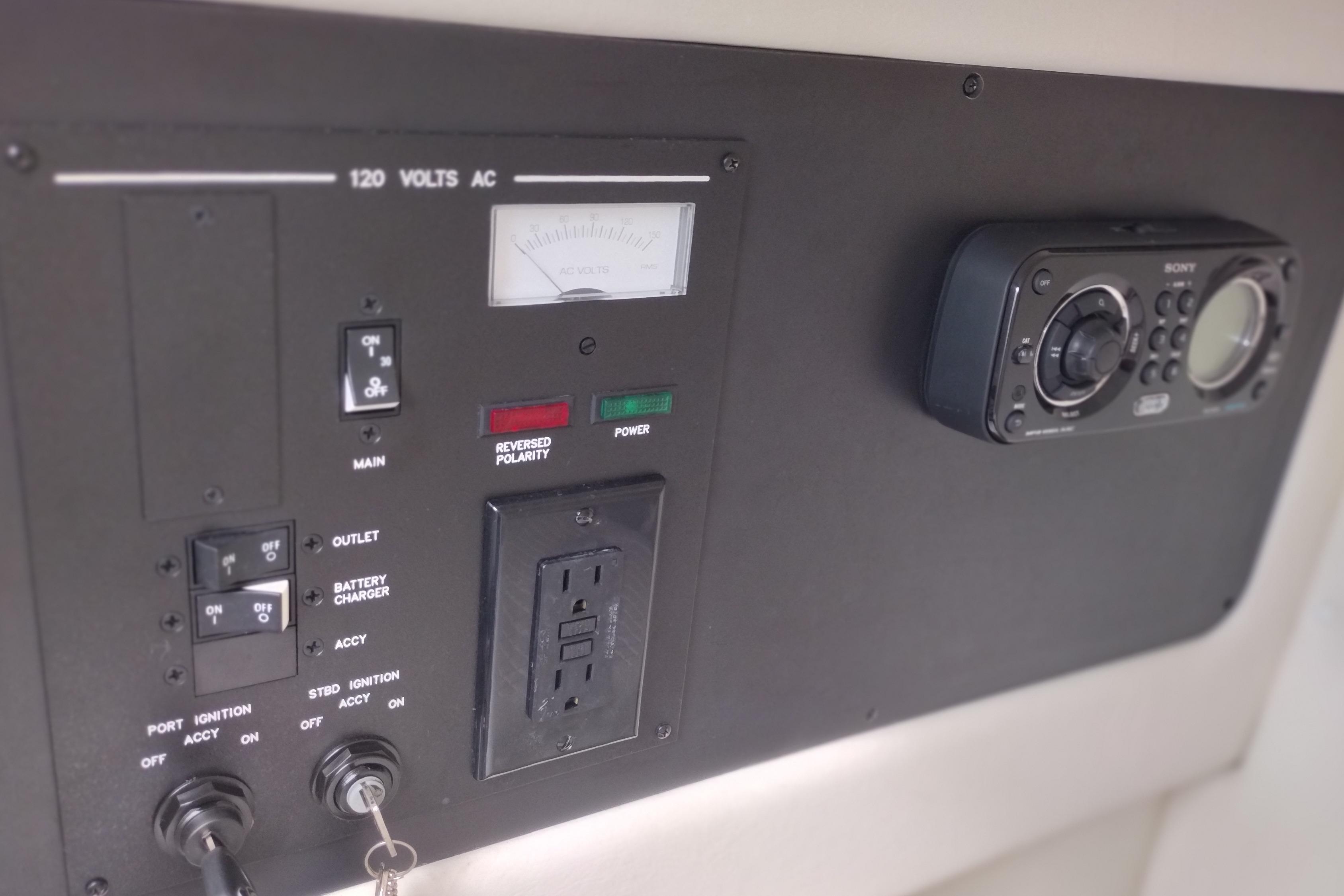 Control panel of a 2013 Sea Ray 300 SLX boat with electrical switches and outlets.