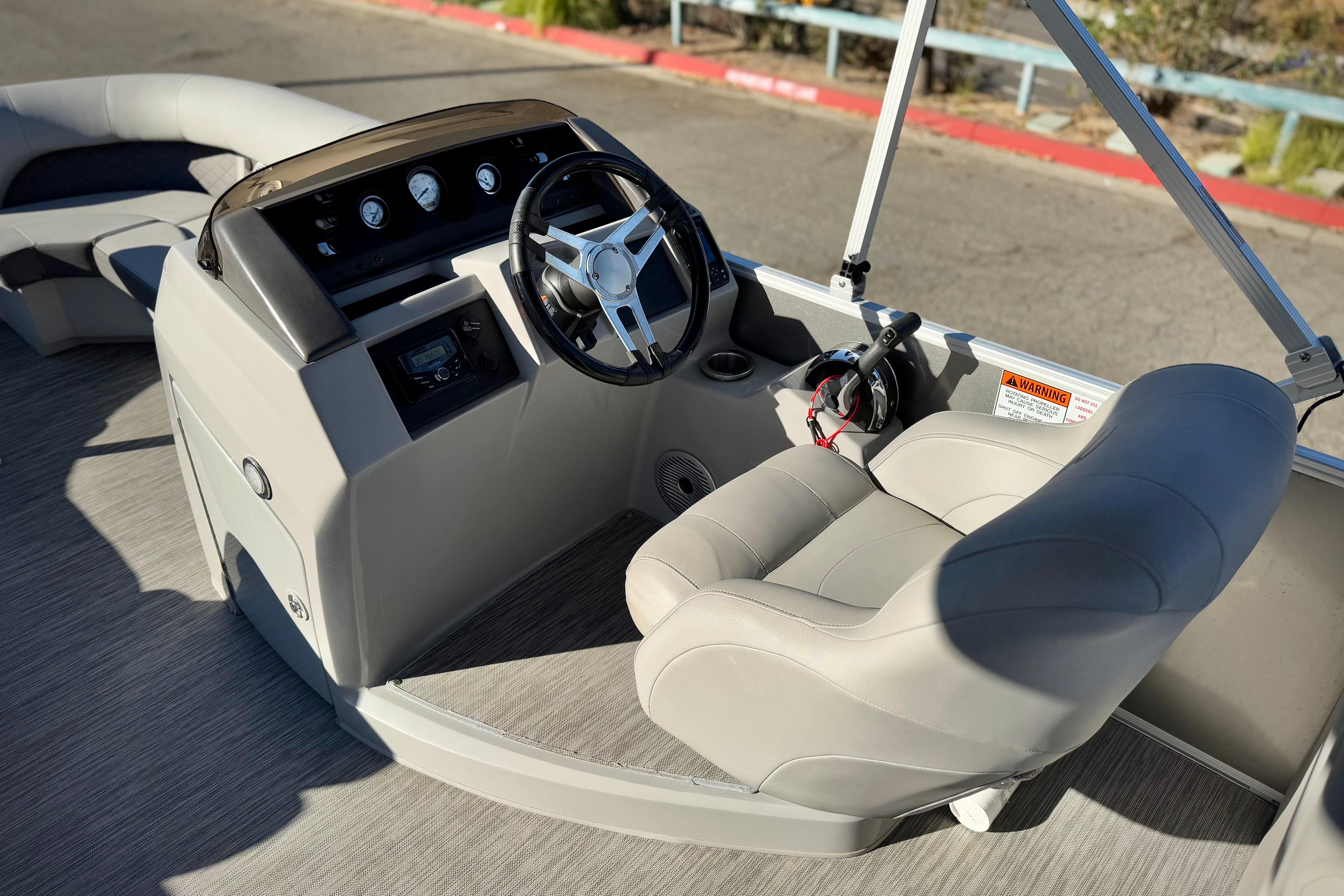 2021 Bennington 23LSR boat interior with steering console and comfortable seating.