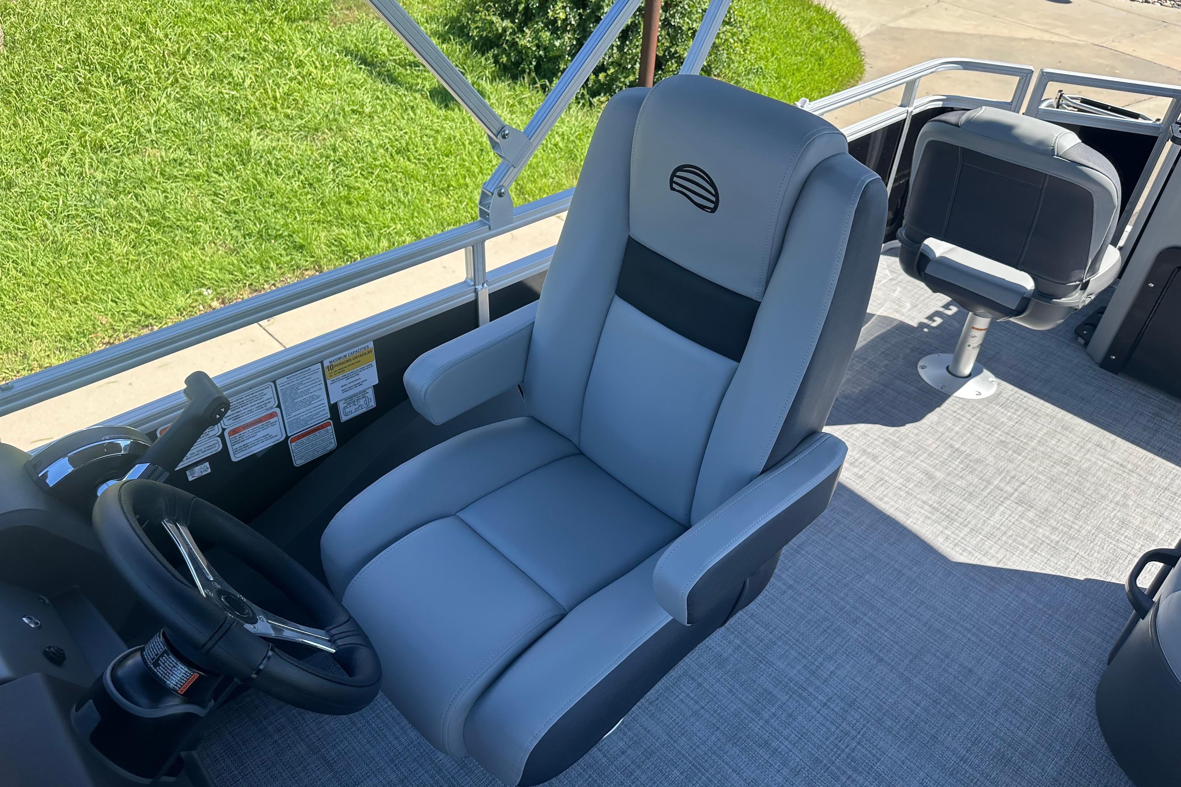 2026 Sun Tracker SportFish 22 DLX boat interior with comfortable captain's chair and steering wheel.