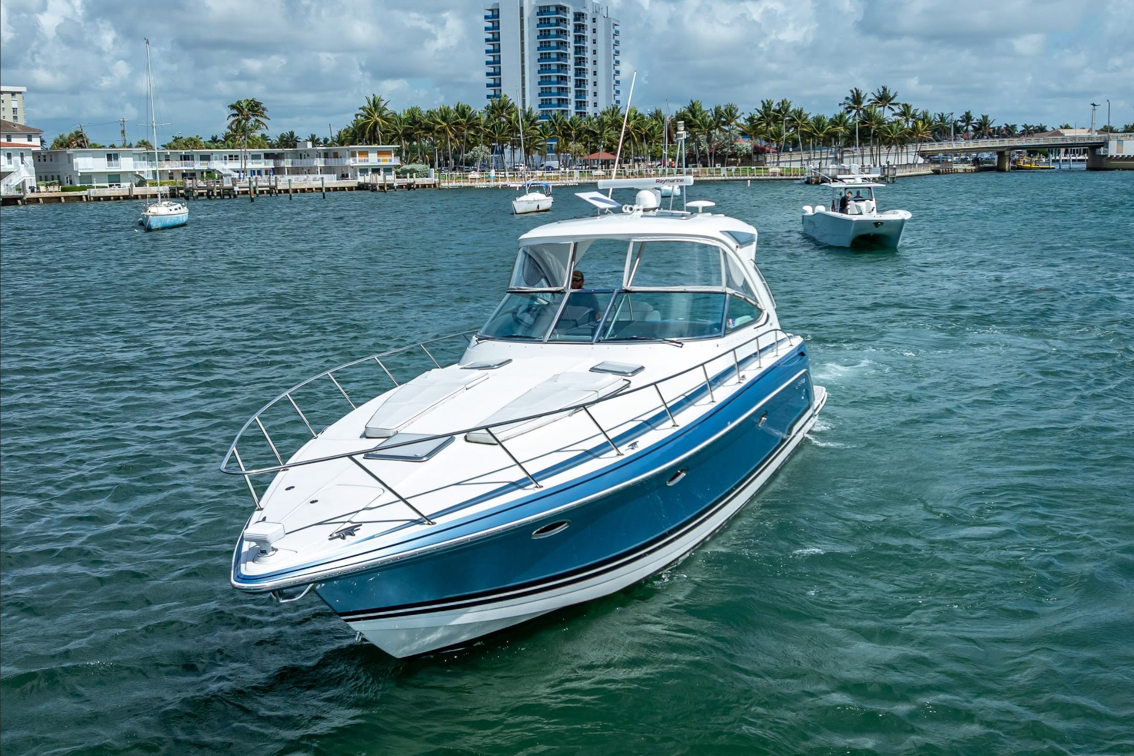2022 Formula 40 Performance Cruiser navigating coastal waters, with buildings and palm trees in background.