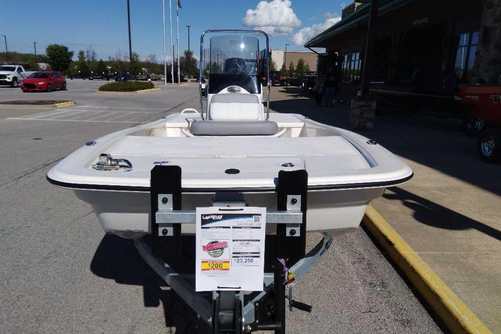 2026 Mako Pro Skiff 13 CC boat on trailer in parking lot, sunny day.