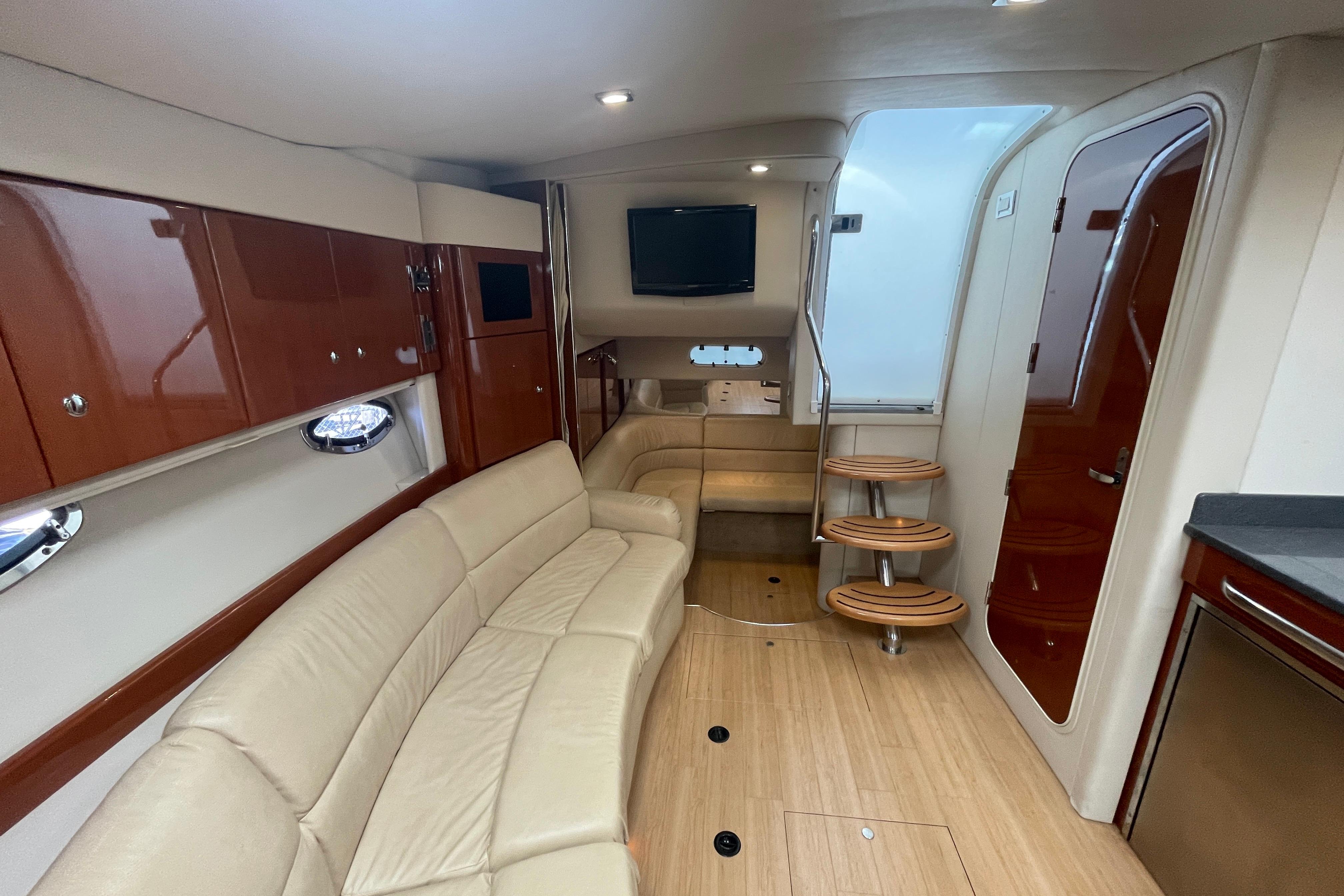 Luxurious interior of a 2011 Formula 34 Performance Cruiser with beige seating and wooden accents.