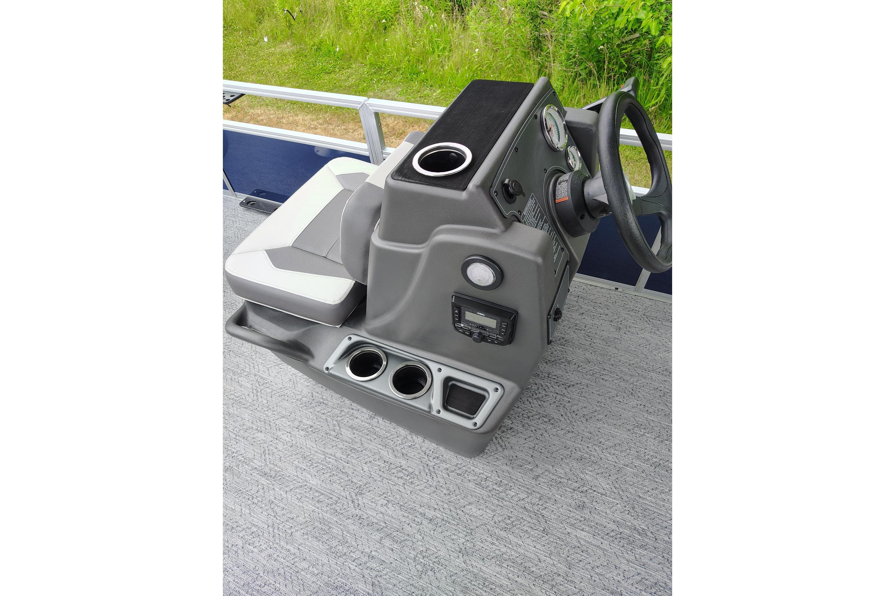 2026 Sun Tracker Bass Buggy 18 DLX boat console with steering wheel and seating.