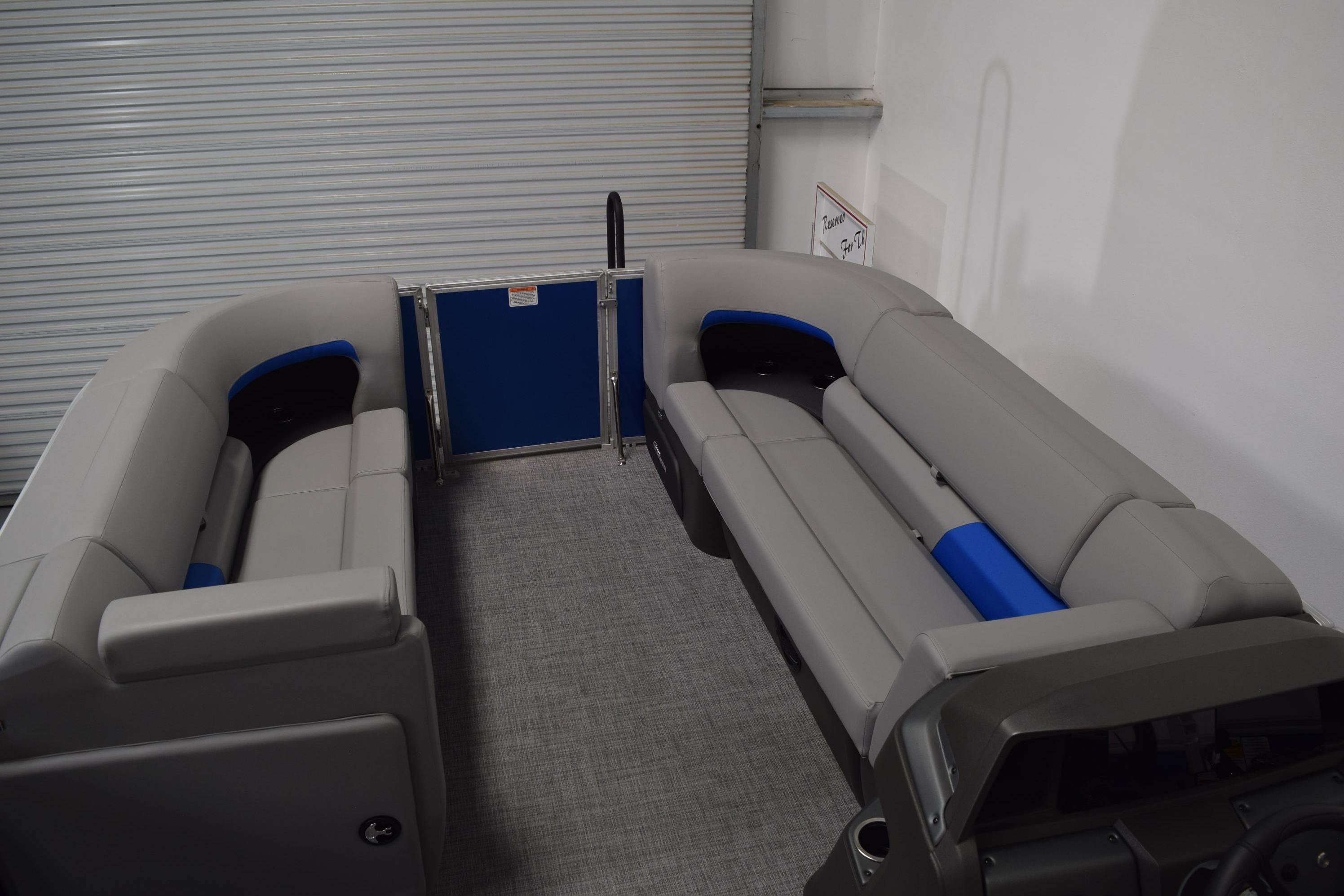 2026 Sun Tracker Party Barge 20 DLX interior with gray and blue seating.