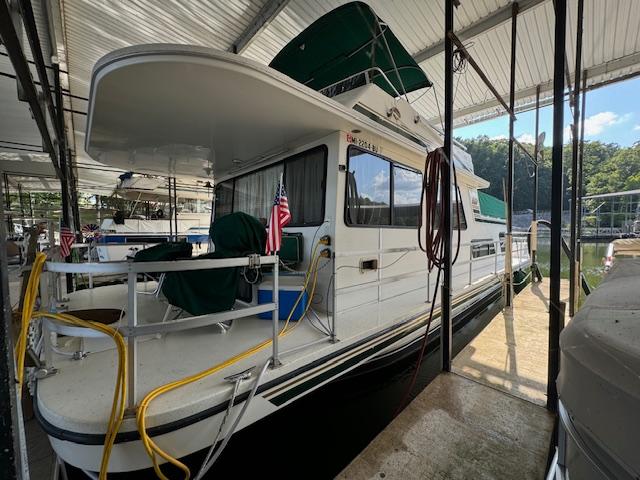 1994 Gibson 44 Standard houseboat docked under a covered marina.