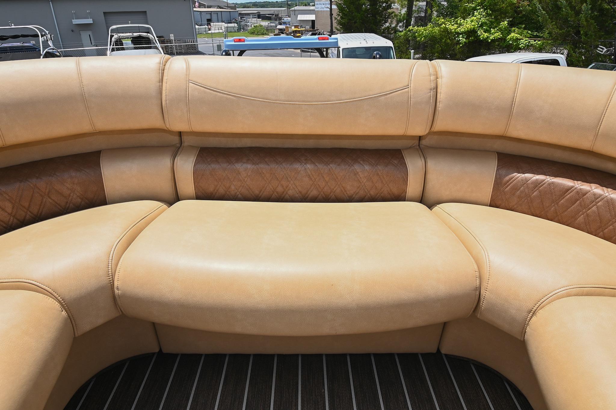 Luxurious tan seating on 2023 Premier 270 Intrigue RF boat, featuring elegant design and comfort.