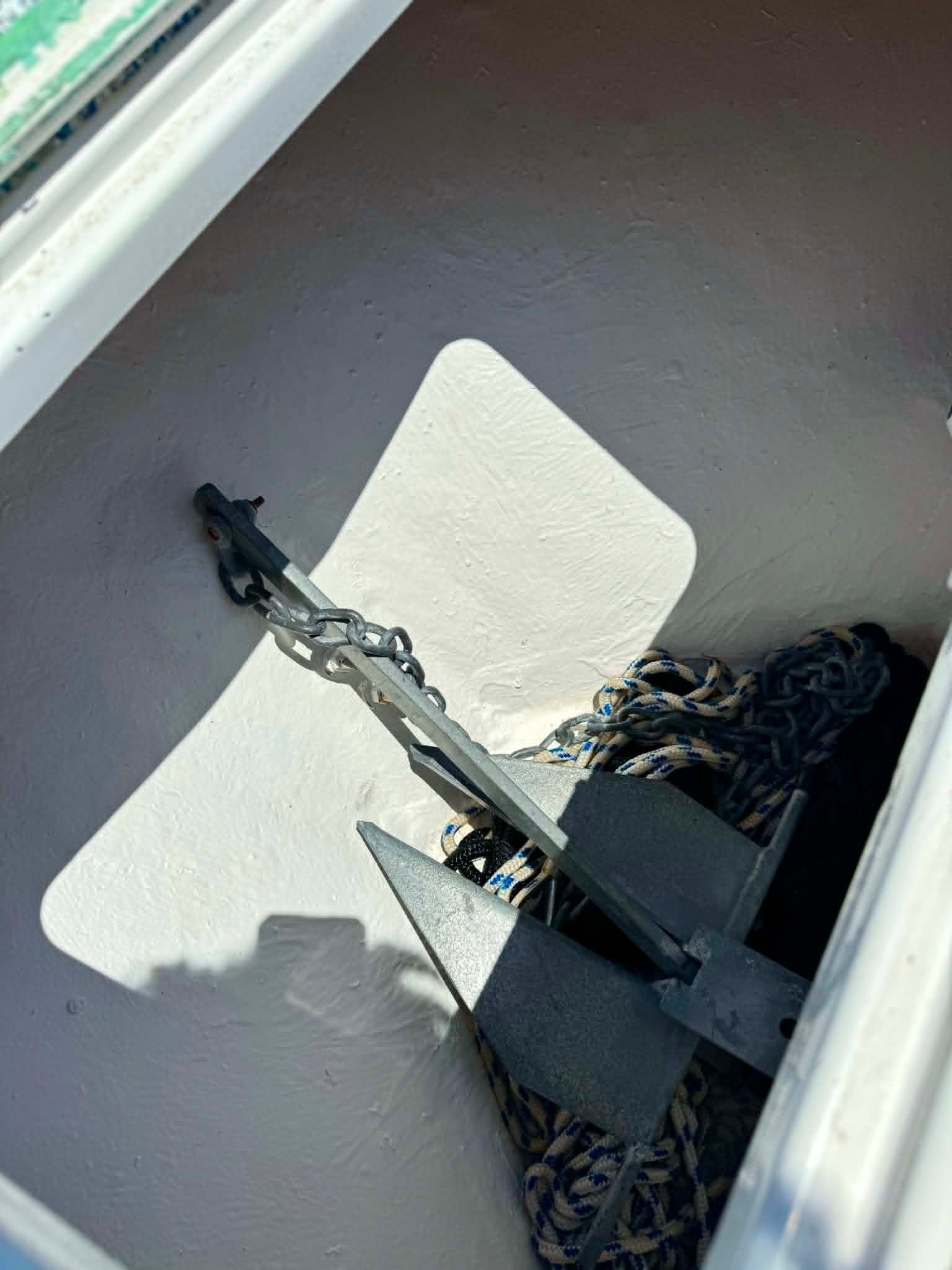 Anchor and rope in storage compartment of a 2023 Dusky 278 XFT boat.