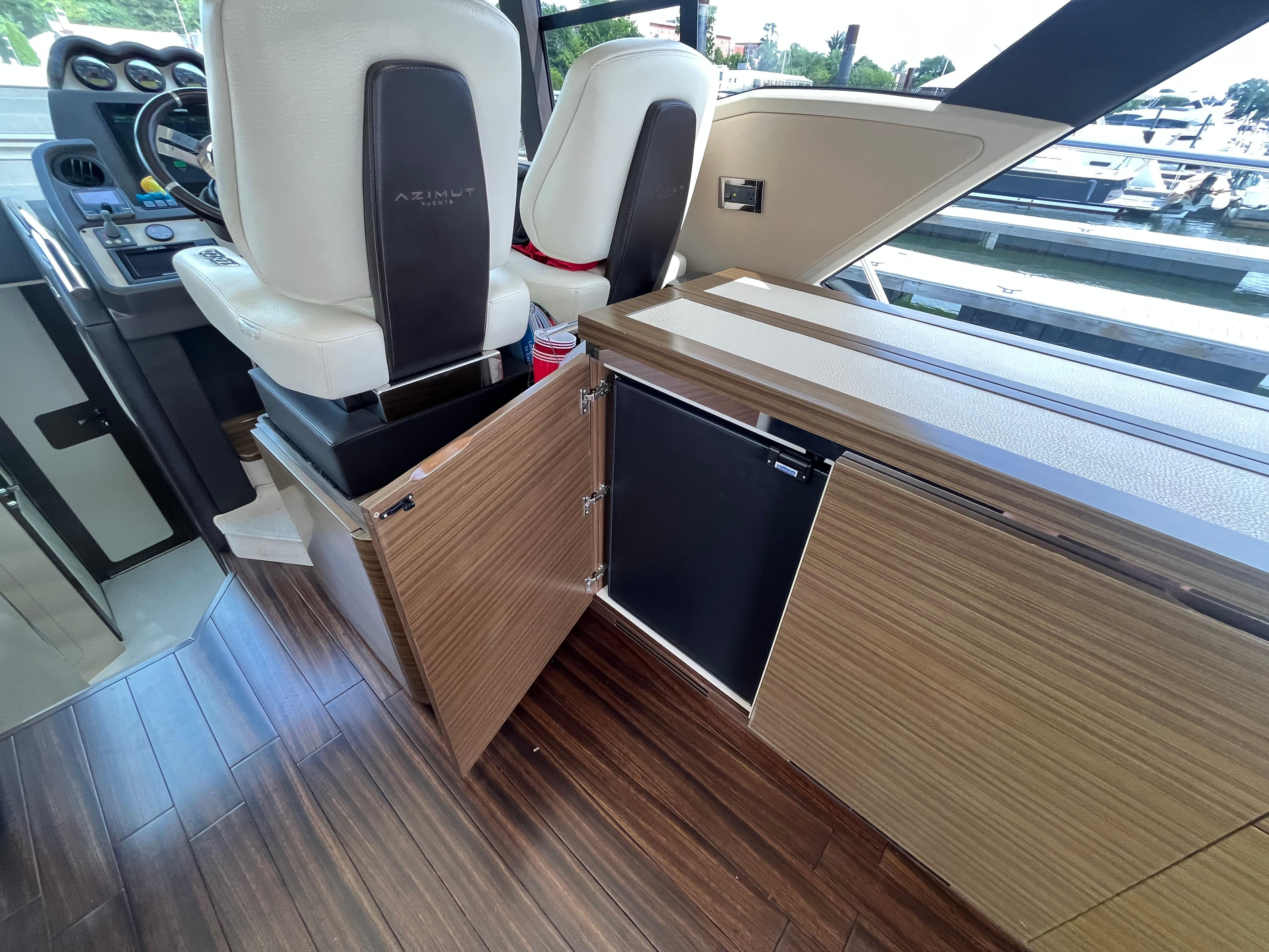 Interior of 2014 Azimut 55S yacht with wood flooring and modern seating.