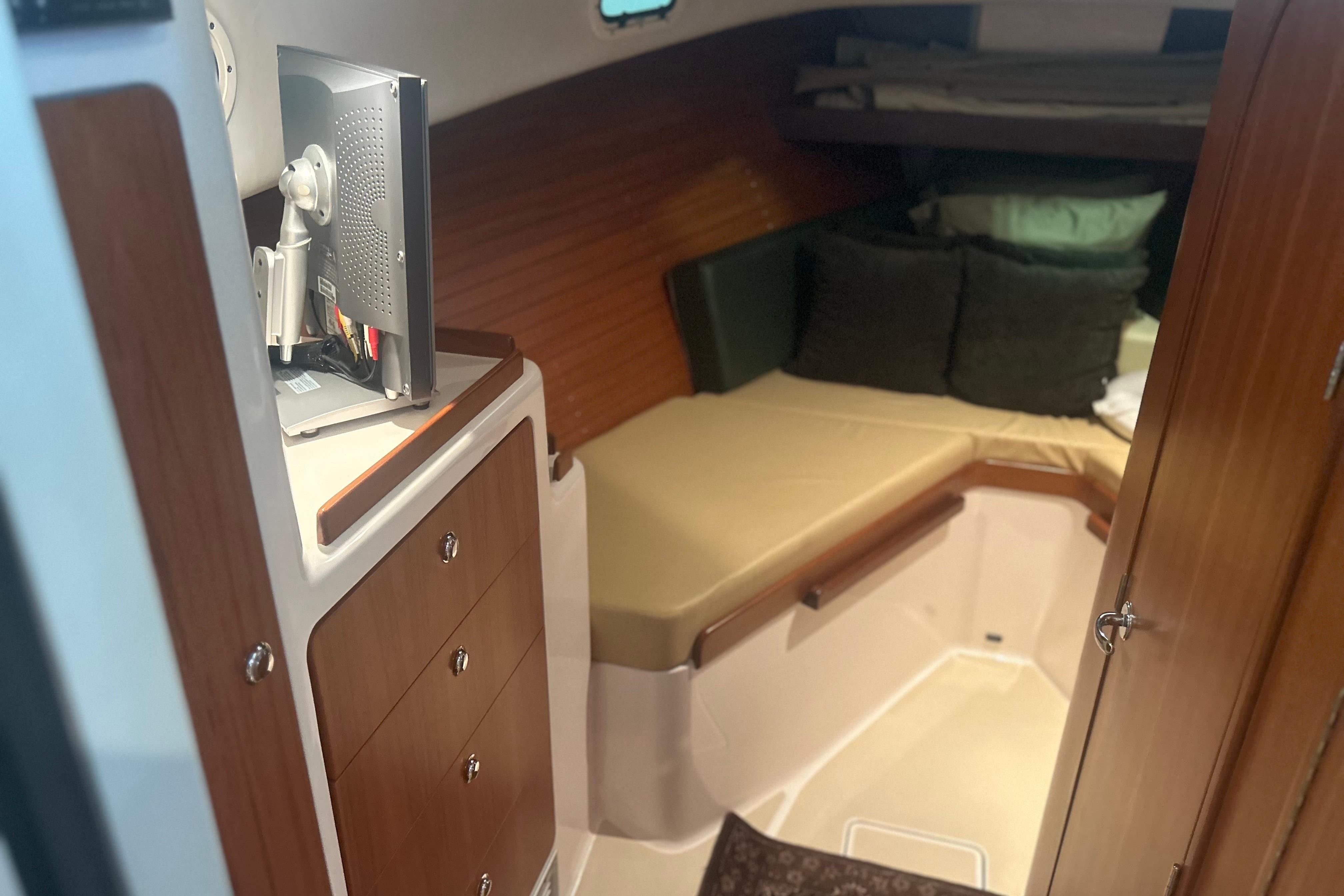 2007 True North 38 Heritage cabin interior with bed, storage, and TV.