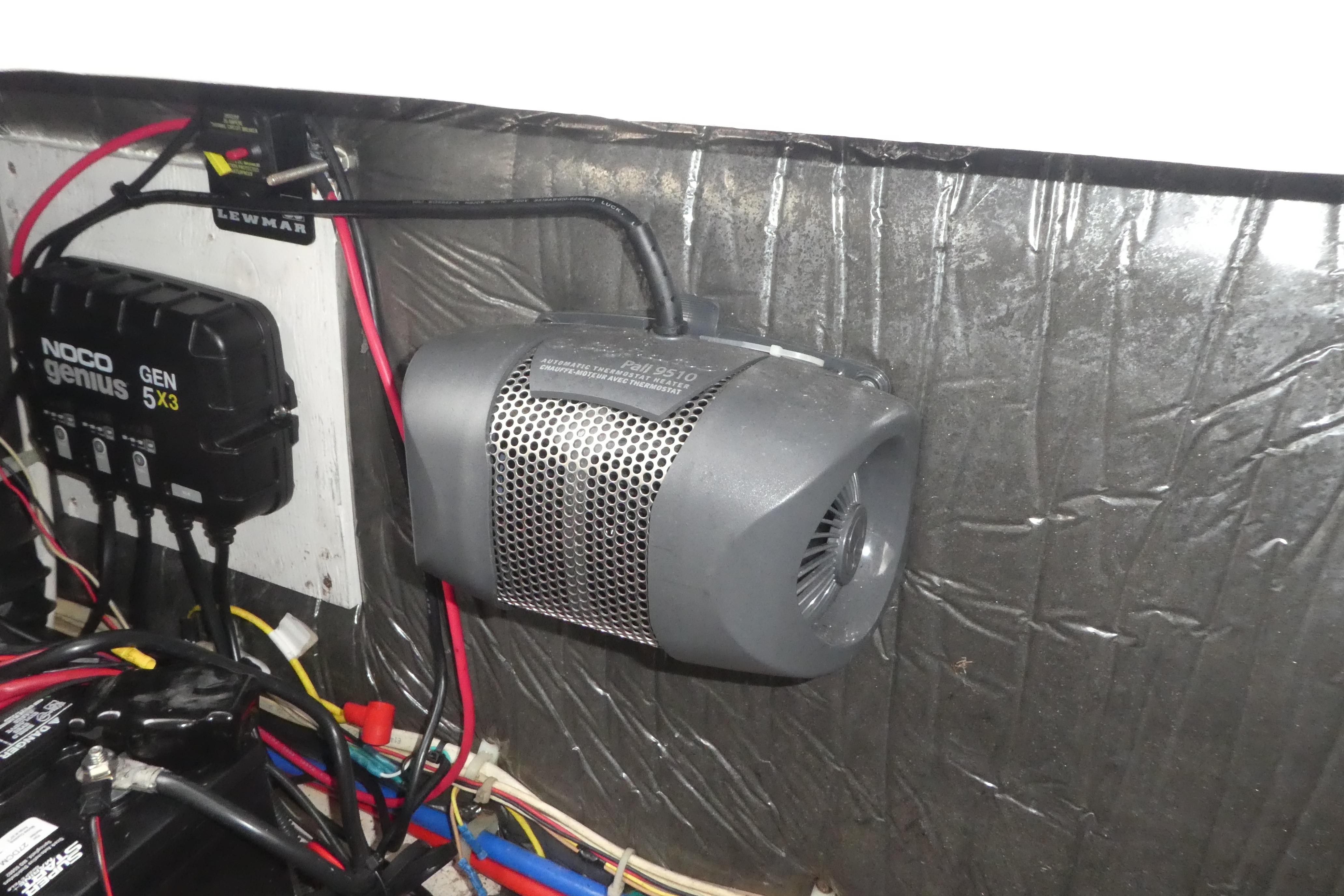 Electrical components inside a 2002 Bayliner 2855 Ciera boat, featuring a NOCO Genius charger.