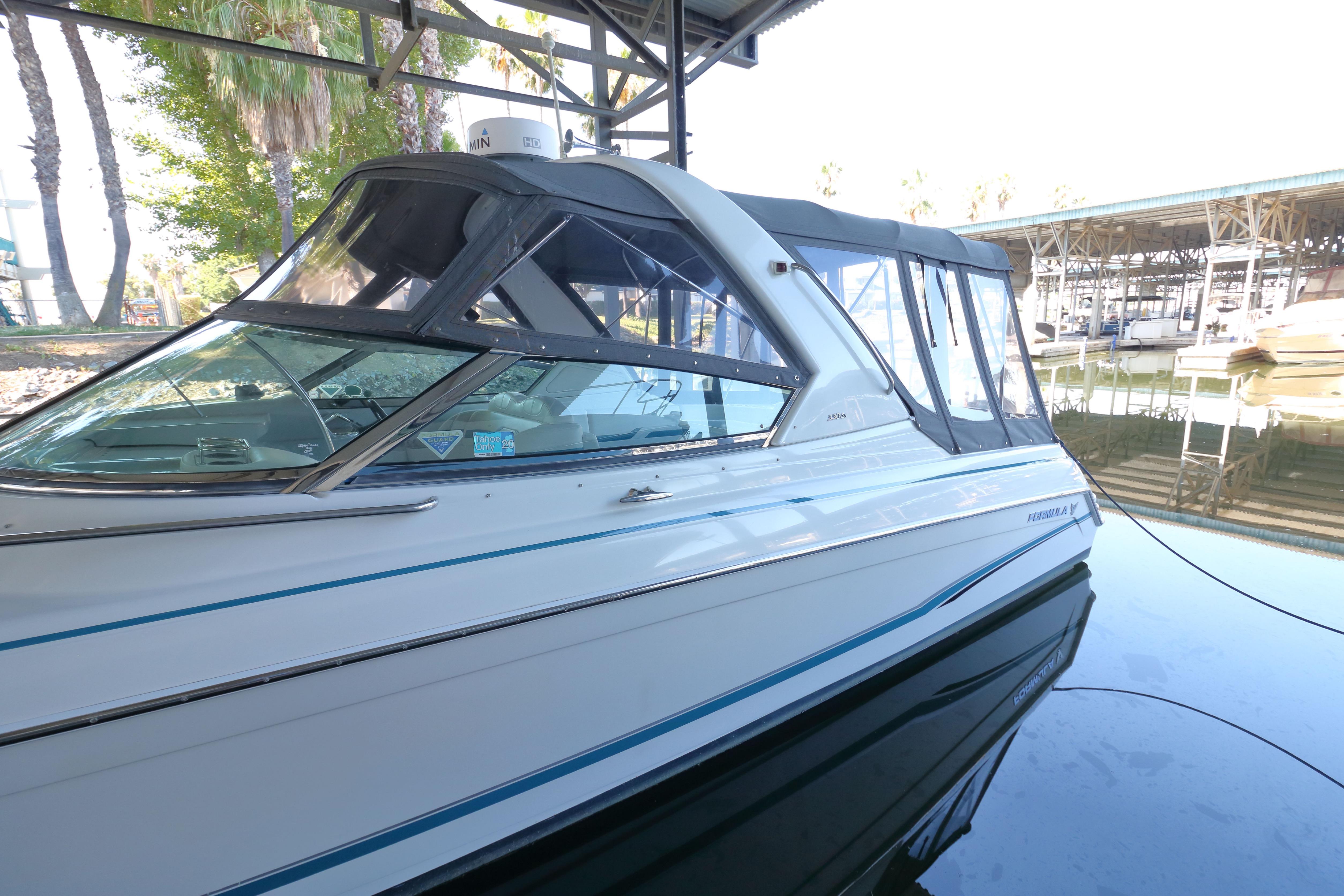 2006 Formula 330 Sun Sport boat docked in a marina, side view.
