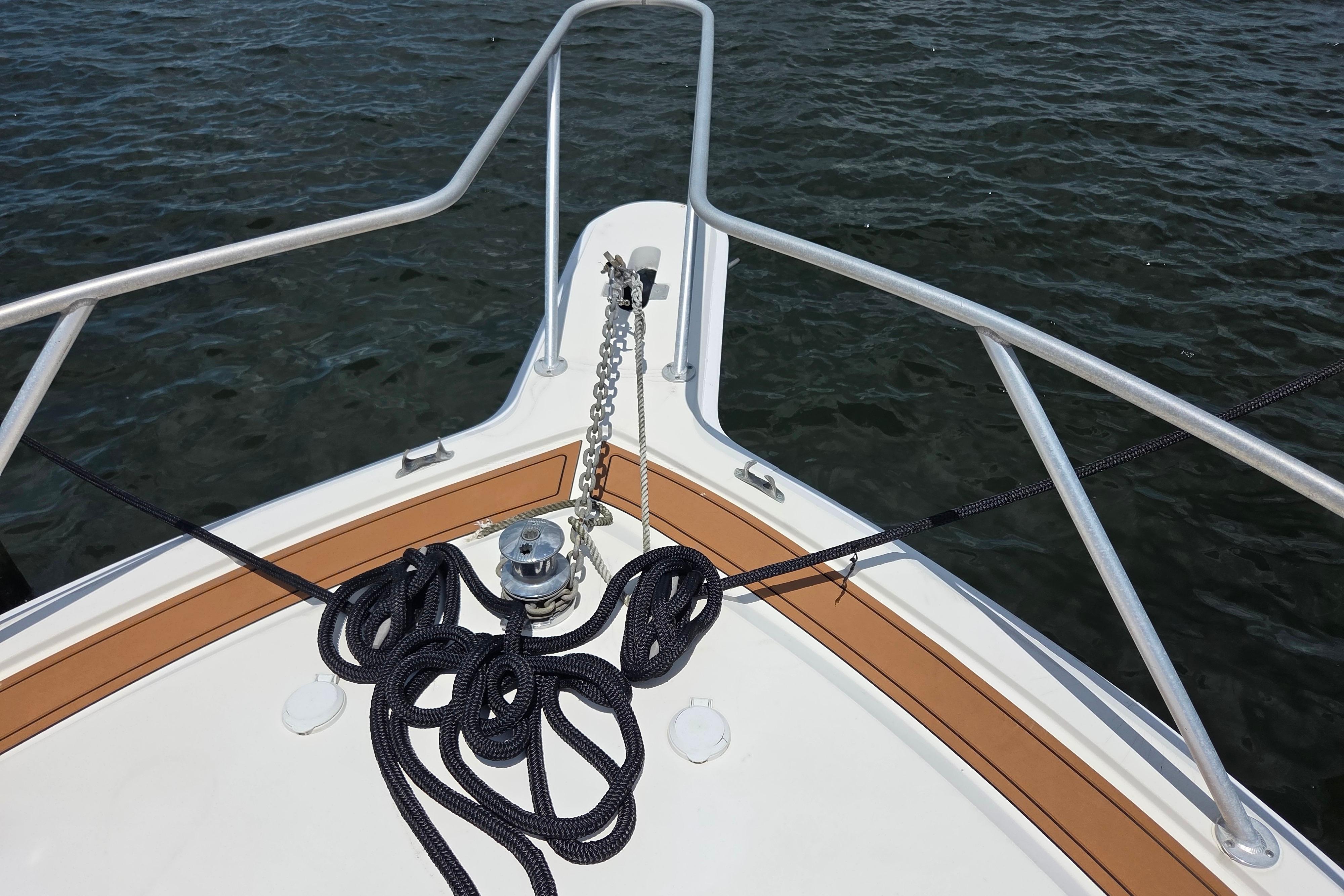 Bow of 1990 Egg Harbor Golden Egg 42 yacht with anchor chain and ropes.