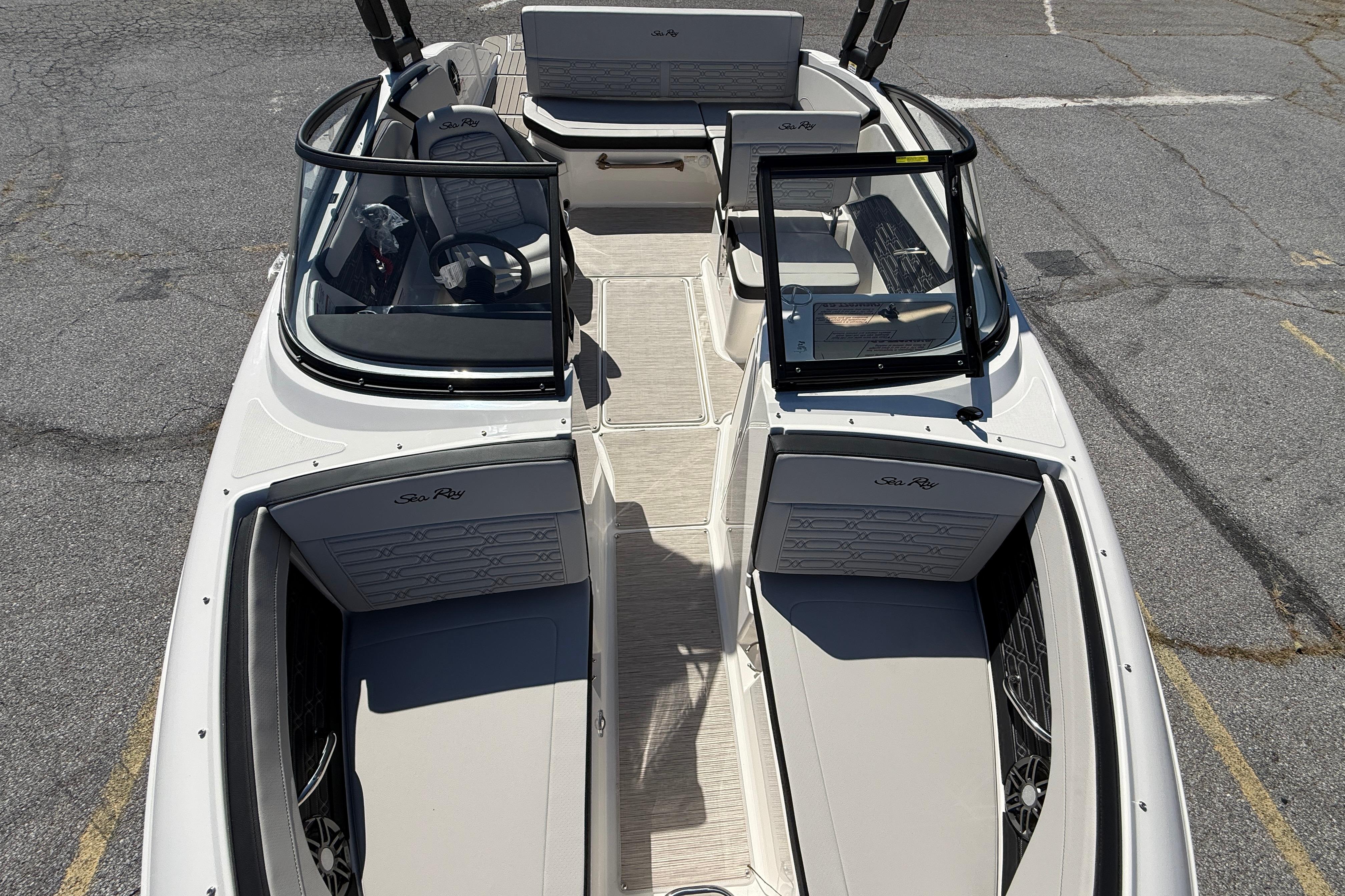 2026 Sea Ray SPX 210 boat interior with seating and steering wheel, viewed from above.