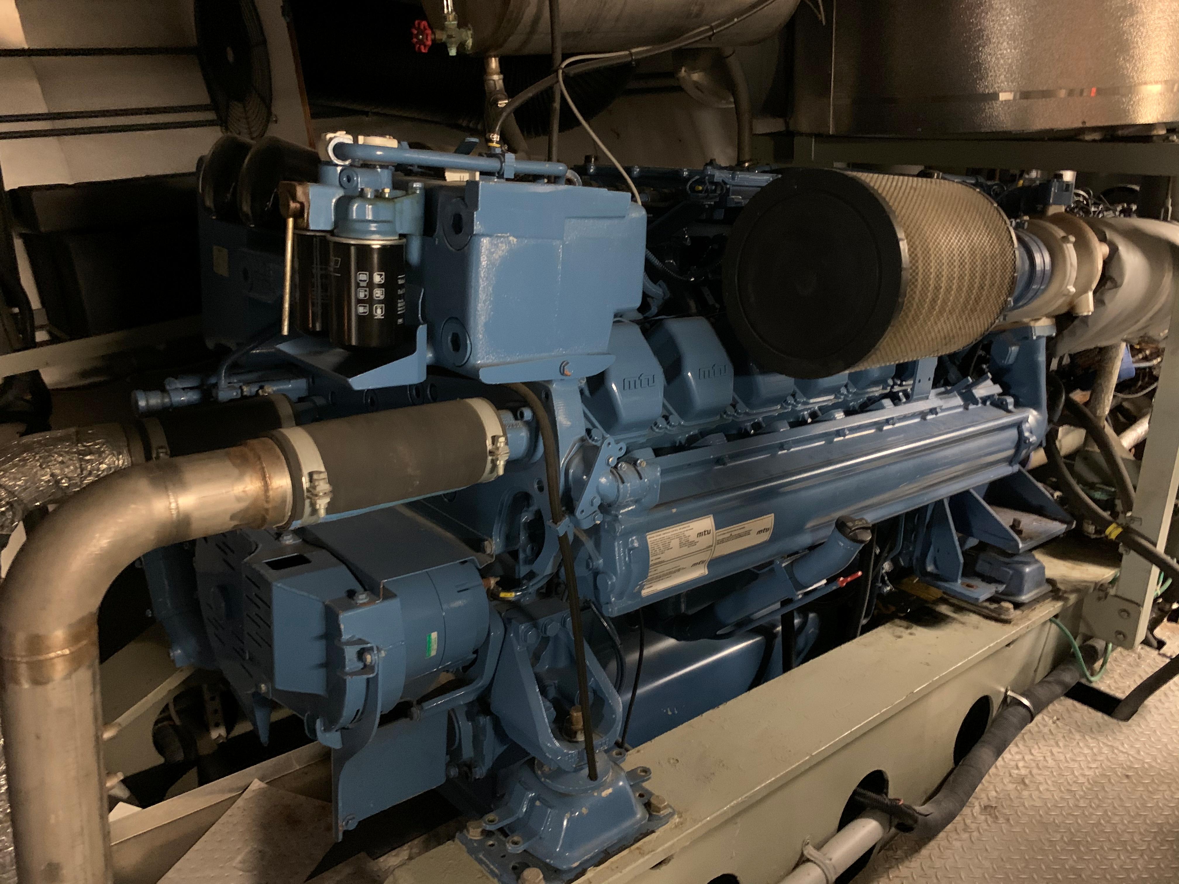 Engine room of a 2012 ferry, showcasing a large blue engine.