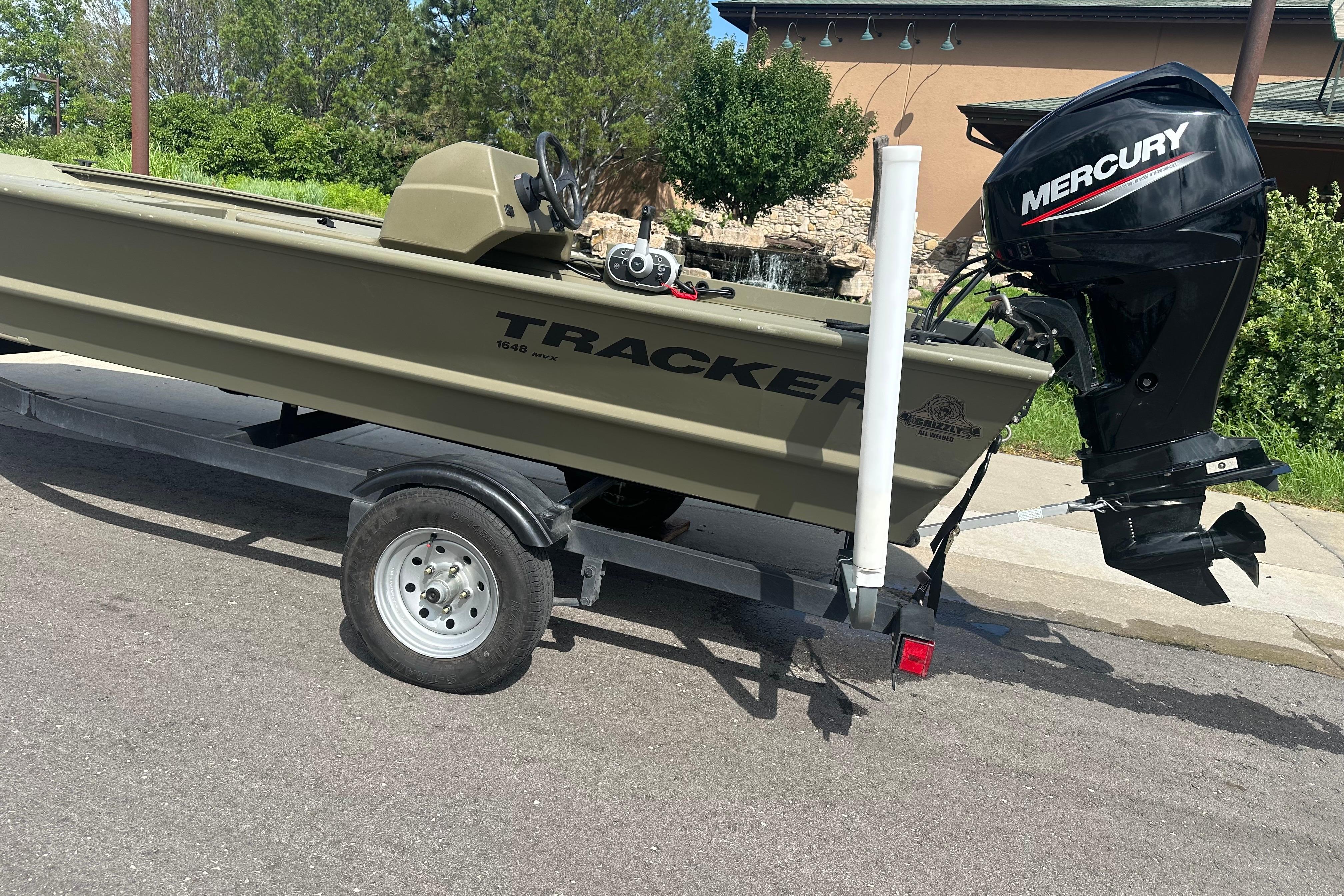 2024 Tracker Grizzly 1648 SC boat with Mercury engine on trailer.
