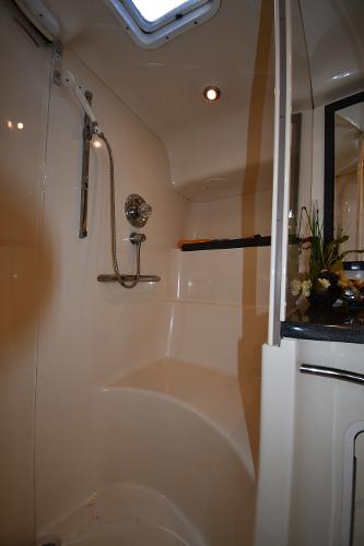 Shower area in 1997 Sea Ray 400 Sundancer yacht, featuring modern fixtures and lighting.