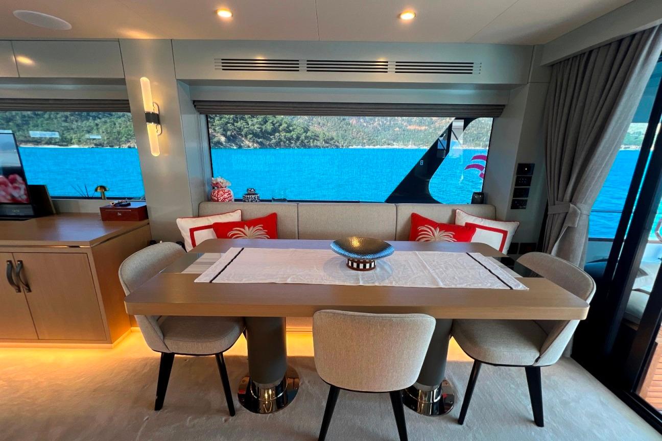 Luxurious interior of 2024 Sirena 68 yacht with elegant dining area and scenic ocean view.