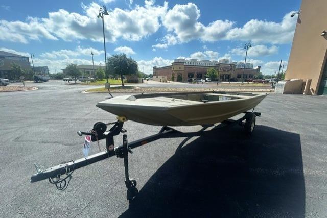 2026 Tracker Grizzly 1648 Utility boat on trailer under a bright blue sky.