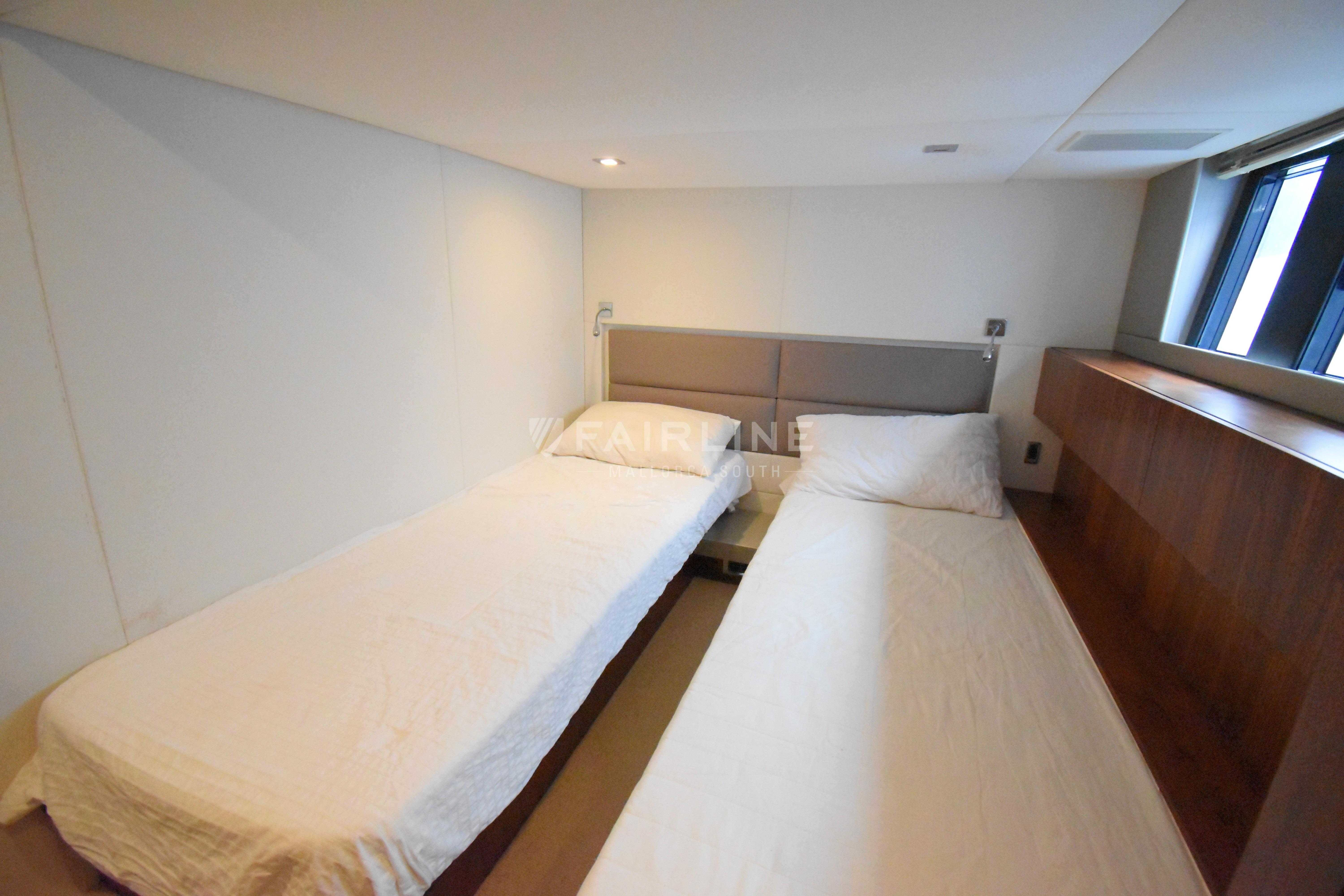 Twin beds in the 2012 Fairline Targa 50 GT yacht cabin, featuring modern design and natural light.