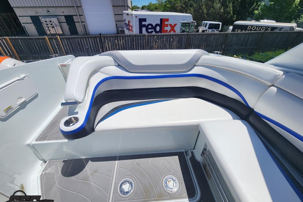 2008 Baja 335 Performance boat interior with white and blue seating, docked near FedEx truck.