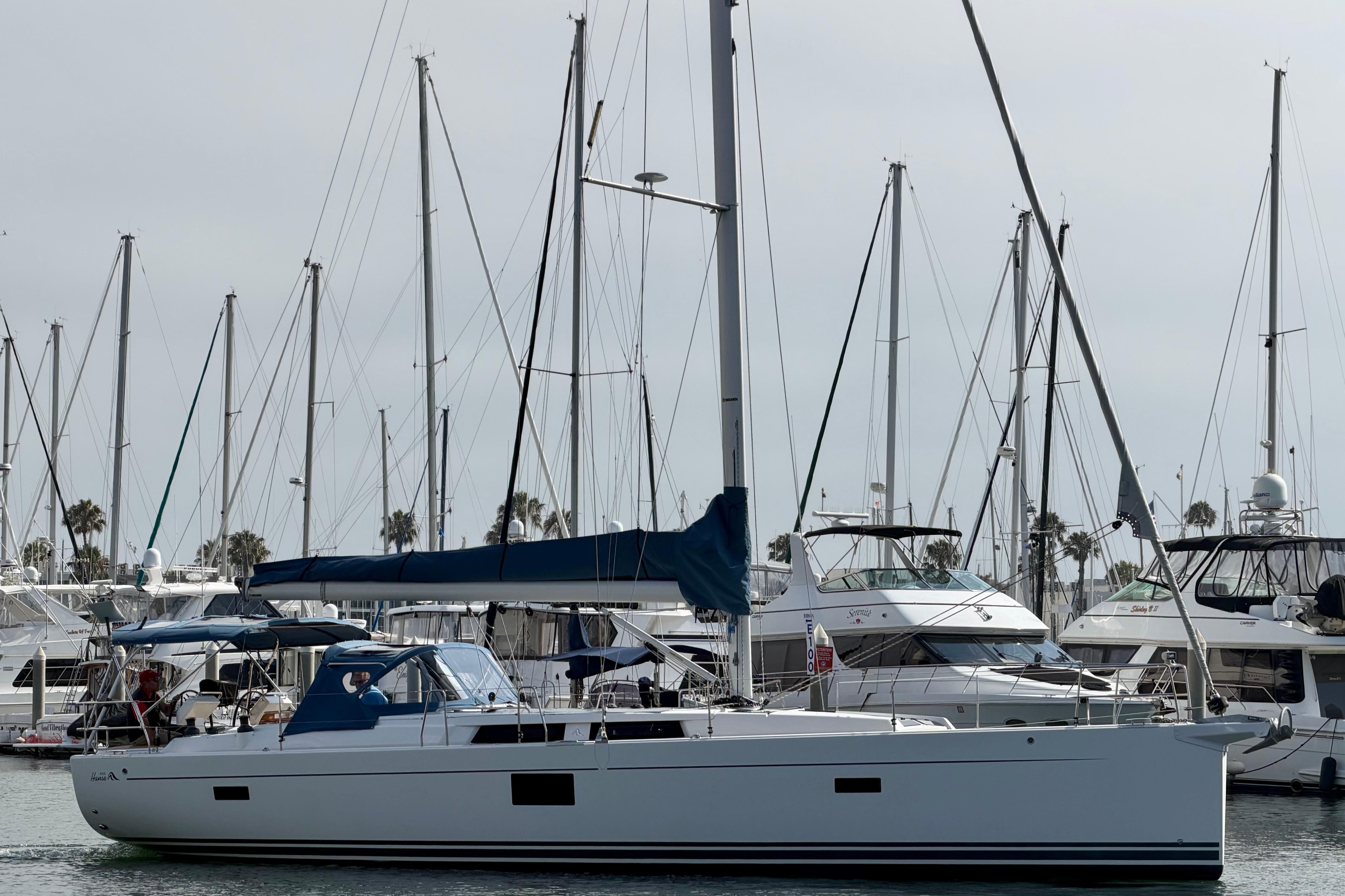 2016 Hanse 455 sailboat docked in a marina, surrounded by other boats.