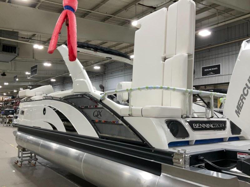 2024 Bennington 27QXSBA-T2 pontoon boat displayed indoors with modern design features.