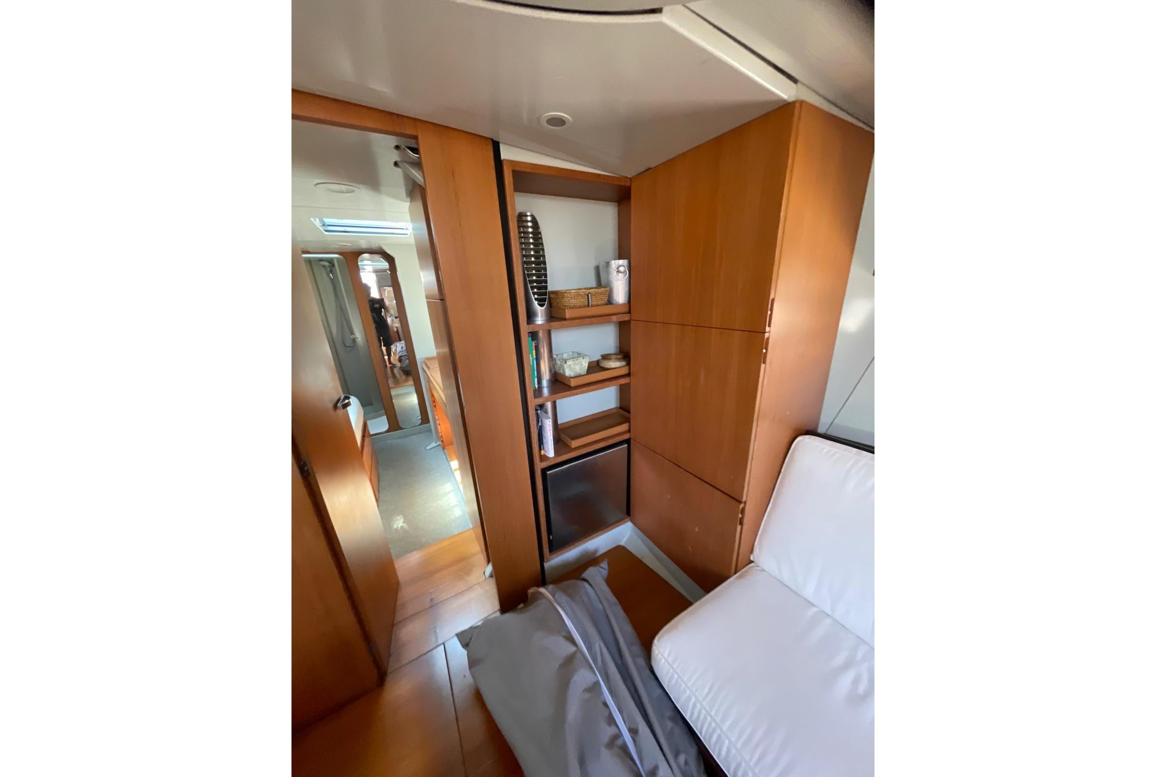 Interior of 2003 Maxi Dolphin 65 yacht with wooden cabinetry and modern furnishings.