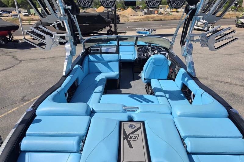 2017 MasterCraft X23 boat with spacious blue interior and advanced audio system.