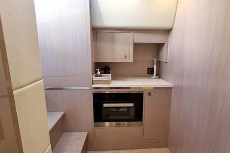 Compact kitchen area in 2017 SACS Strider 18 yacht with modern appliances and cabinetry.