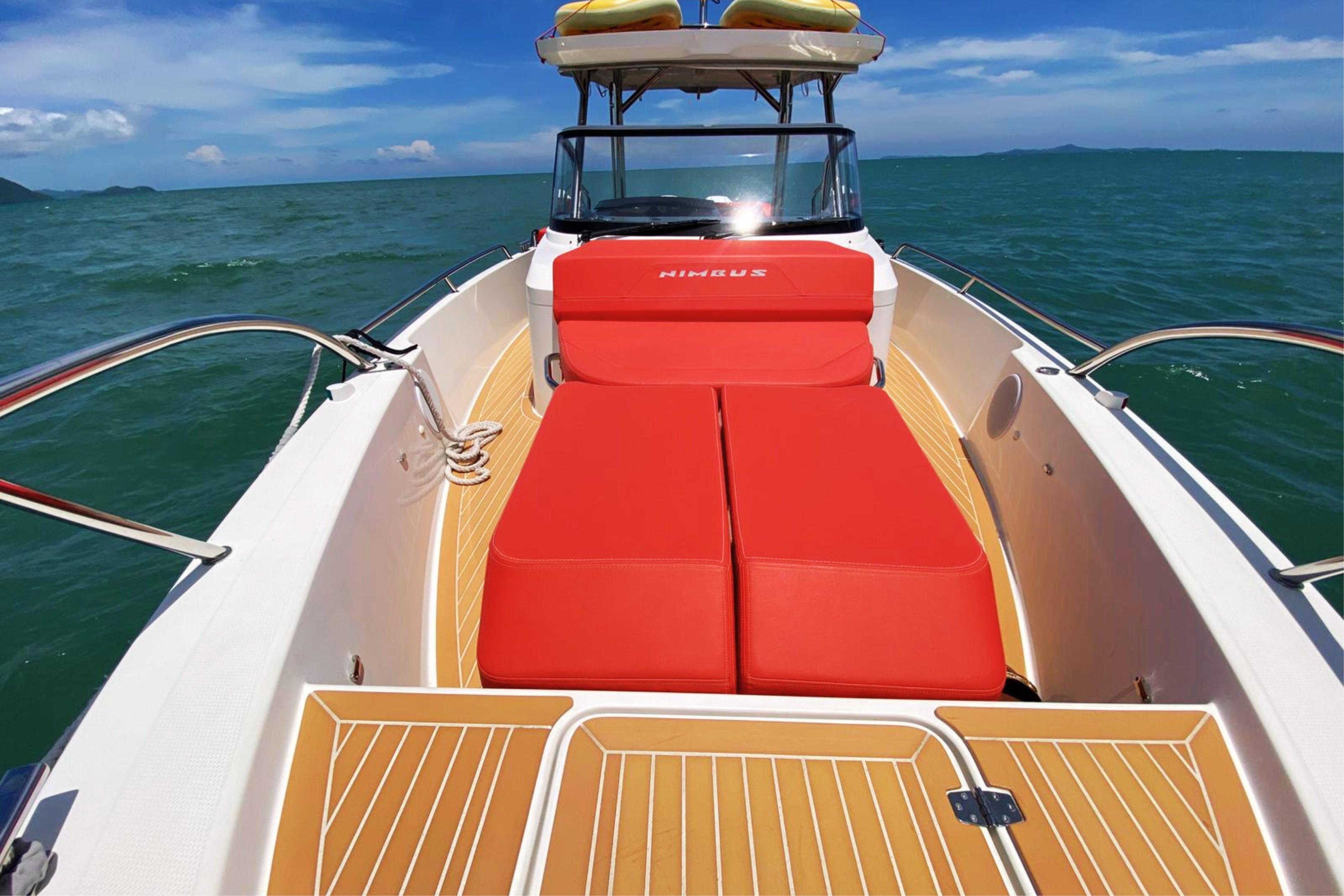 2024 Nimbus Tender 9 boat with red seating, cruising on open water.