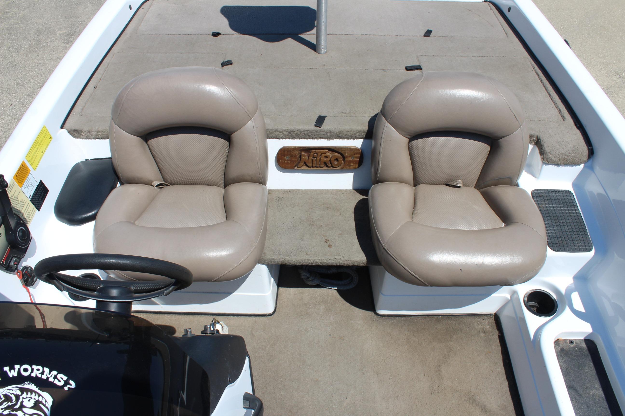 2003 Nitro NX 750 SC boat interior with dual beige seats and steering wheel.