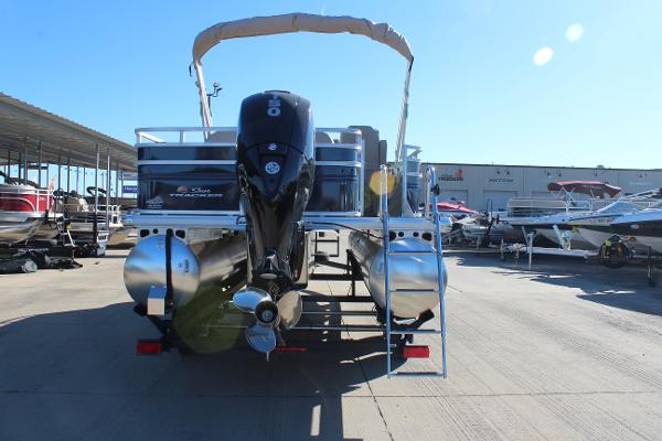 2025 Sun Tracker Fishin' Barge 22 DLX pontoon boat at a marina.