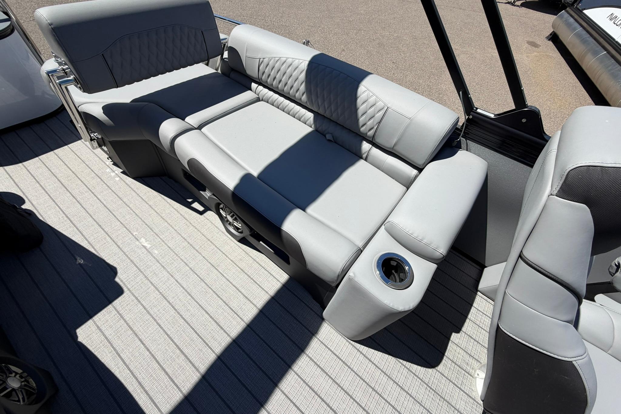Luxurious seating on 2026 Avalon Catalina Quad Lounge Shift boat, featuring sleek gray upholstery.