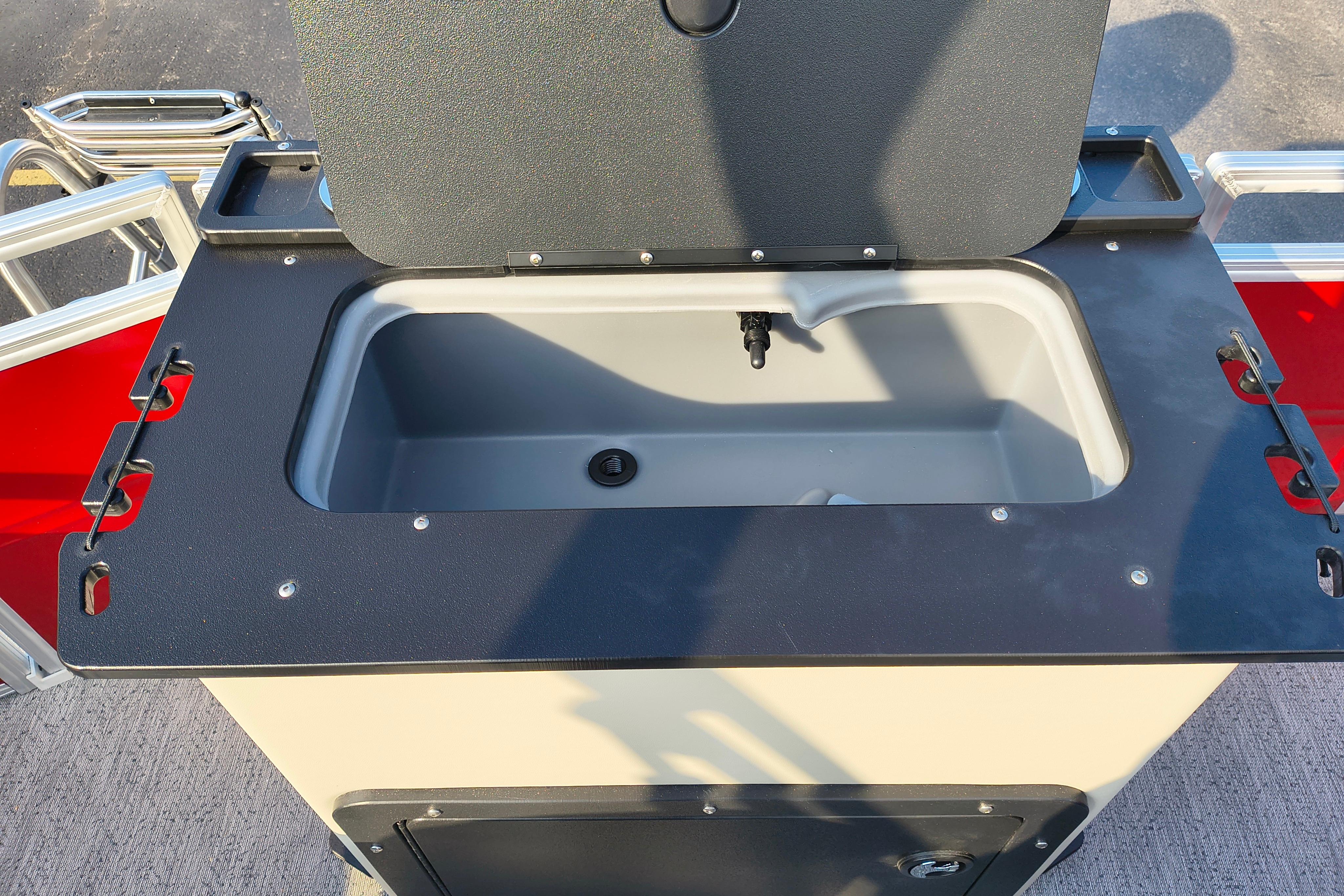 Livewell on 2026 Sun Tracker Fishin' Barge 22 DLX pontoon boat, open lid view.