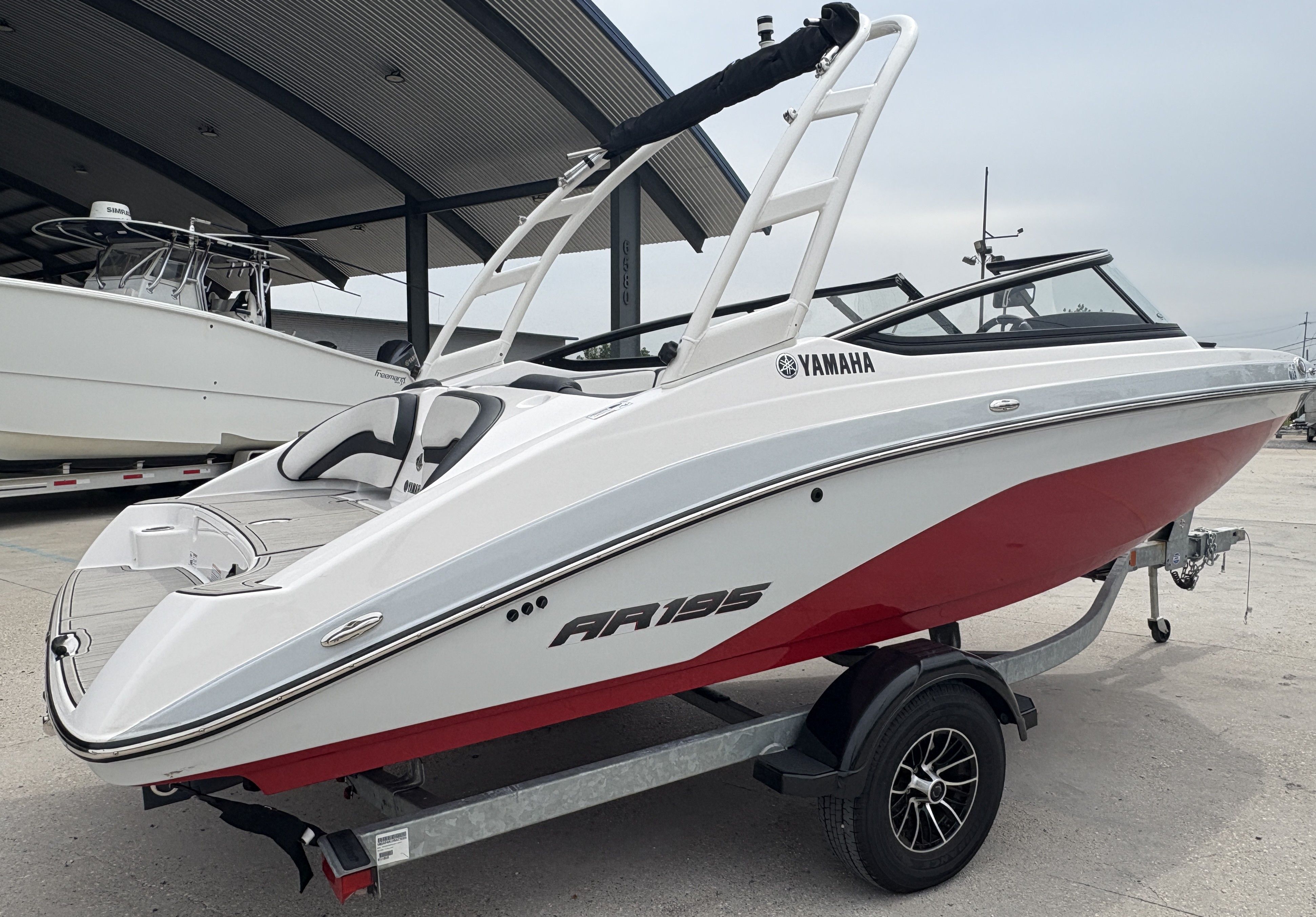 2024 Yamaha AR 195 boat with red and white design on a trailer.