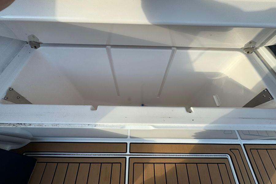 Open storage compartment on 2002 Viking 61 Enclosed Bridge yacht, featuring teak flooring.