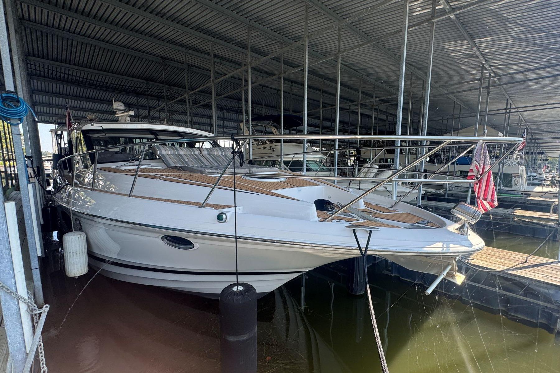 2016 Regal 46 Sport Coupe yacht docked in covered marina.