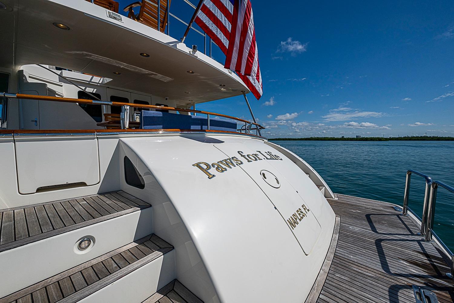 Luxury yacht Marlow 80 Explorer 2014, docked with American flag, sunny day.